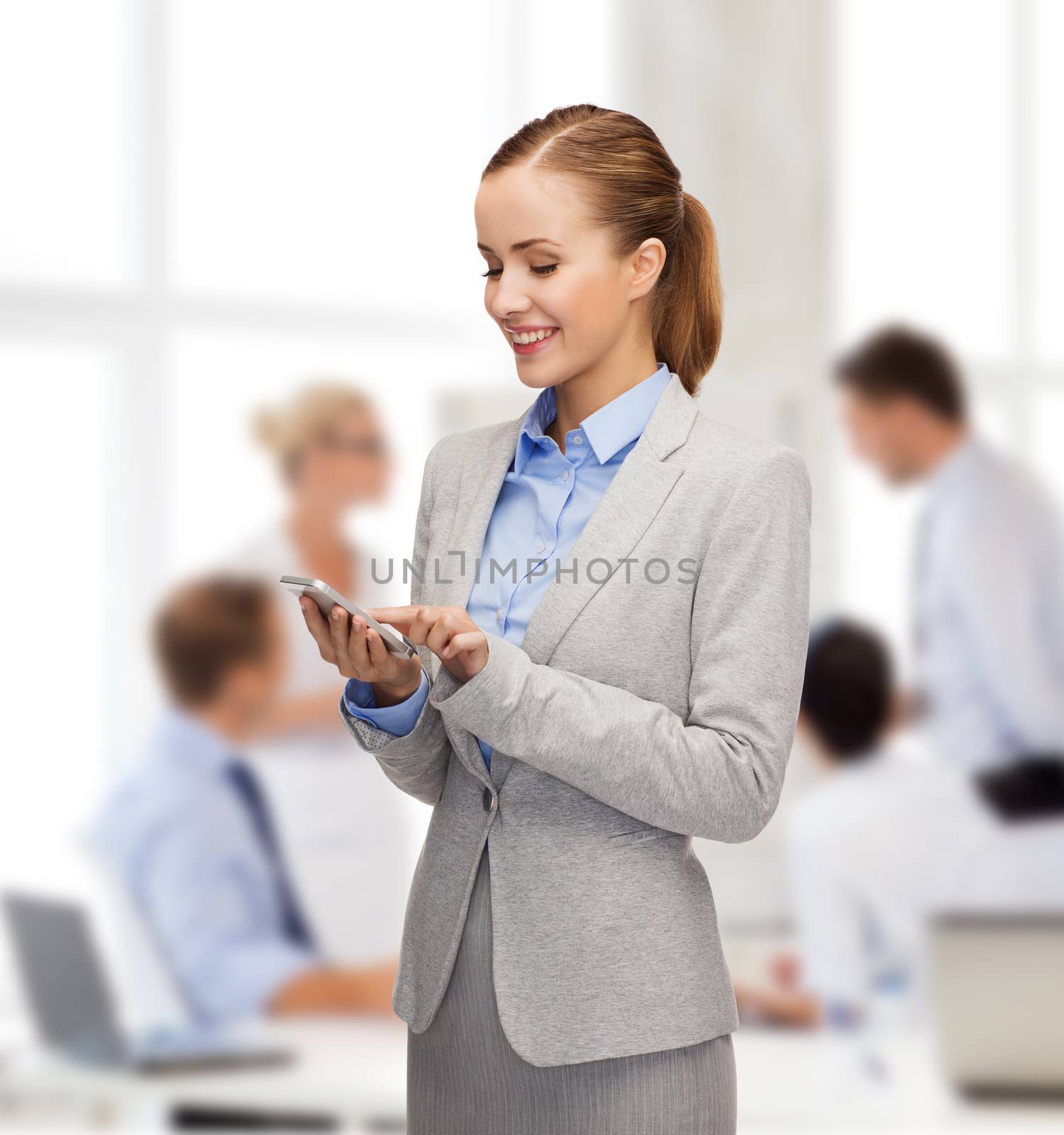 young smiling businesswoman with smartphone by dolgachov