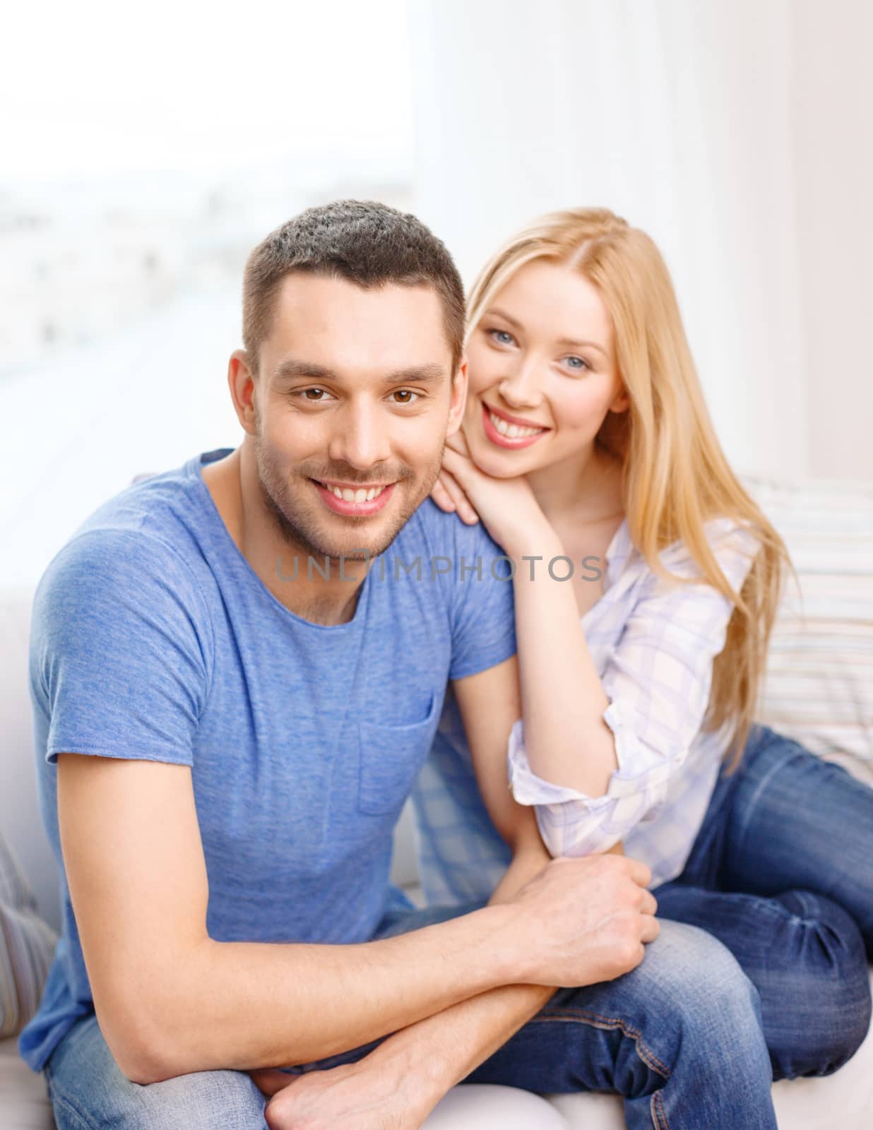 love, family and happiness concept - smiling happy couple at home