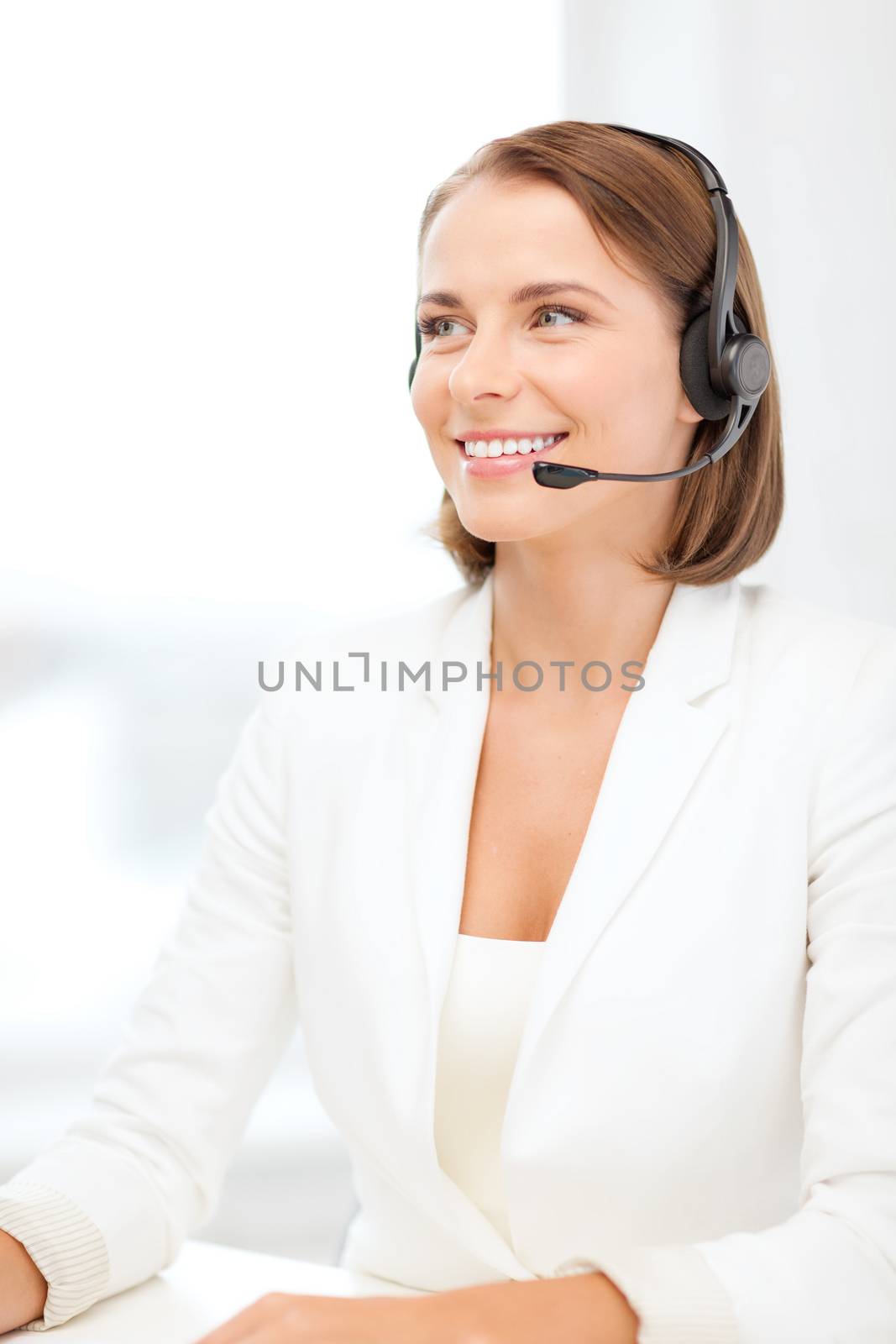 smiling female helpline operator with headphones by dolgachov