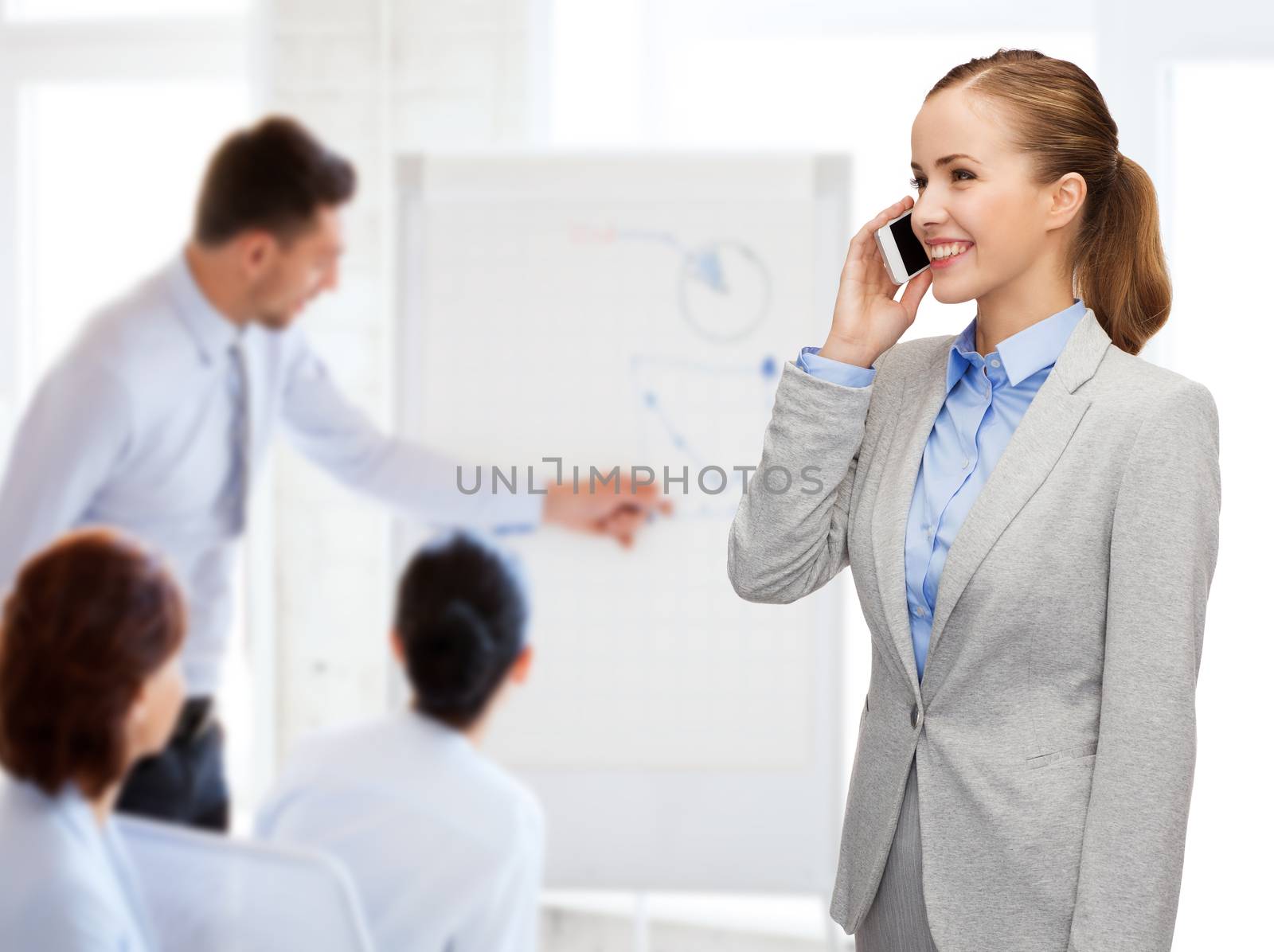 business, technology and education concept - friendly young smiling businesswoman with smartphone