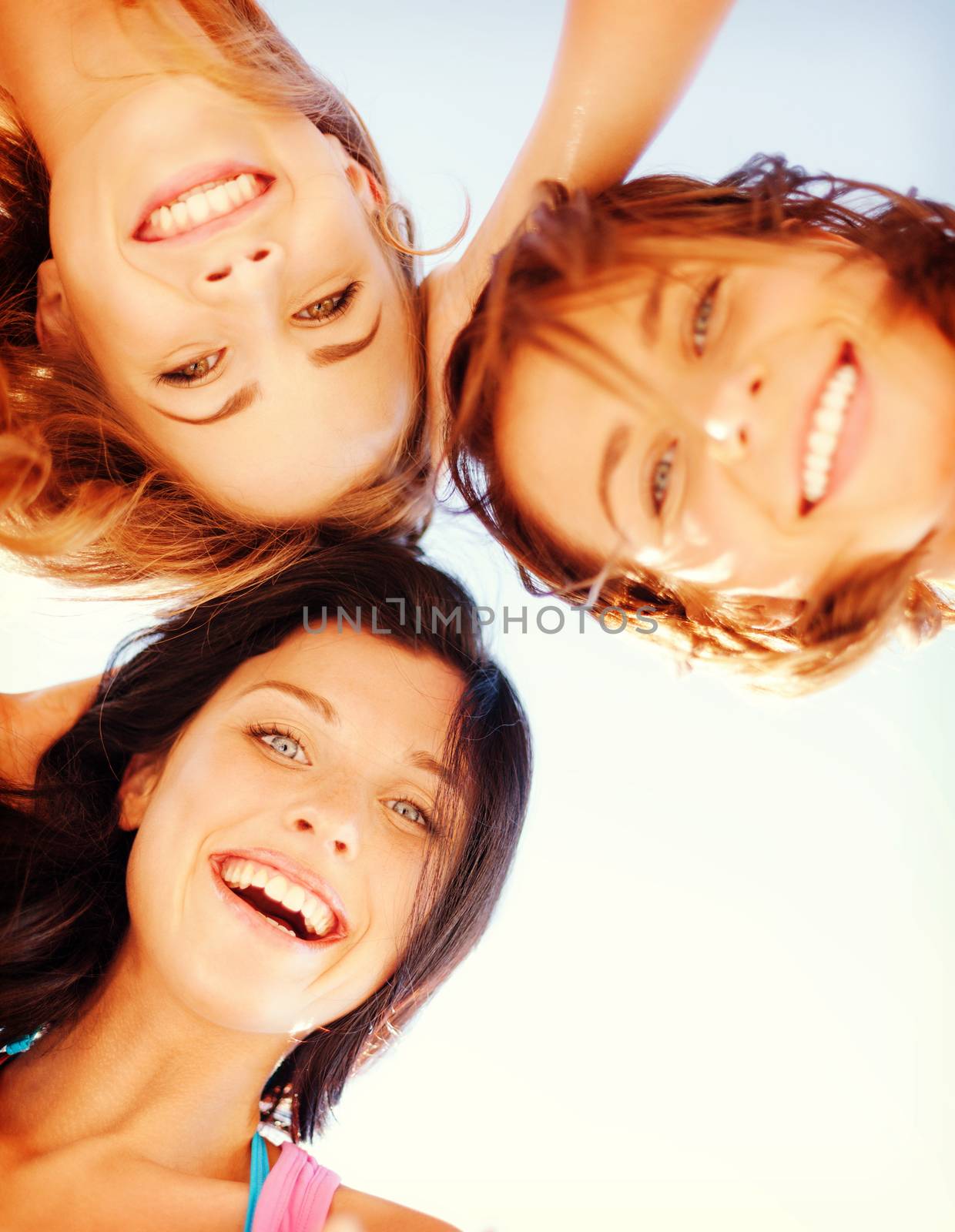 summer holidays and vacation - girls faces with shades looking down