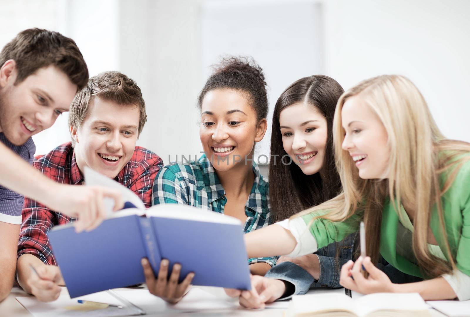 students reading book at school by dolgachov