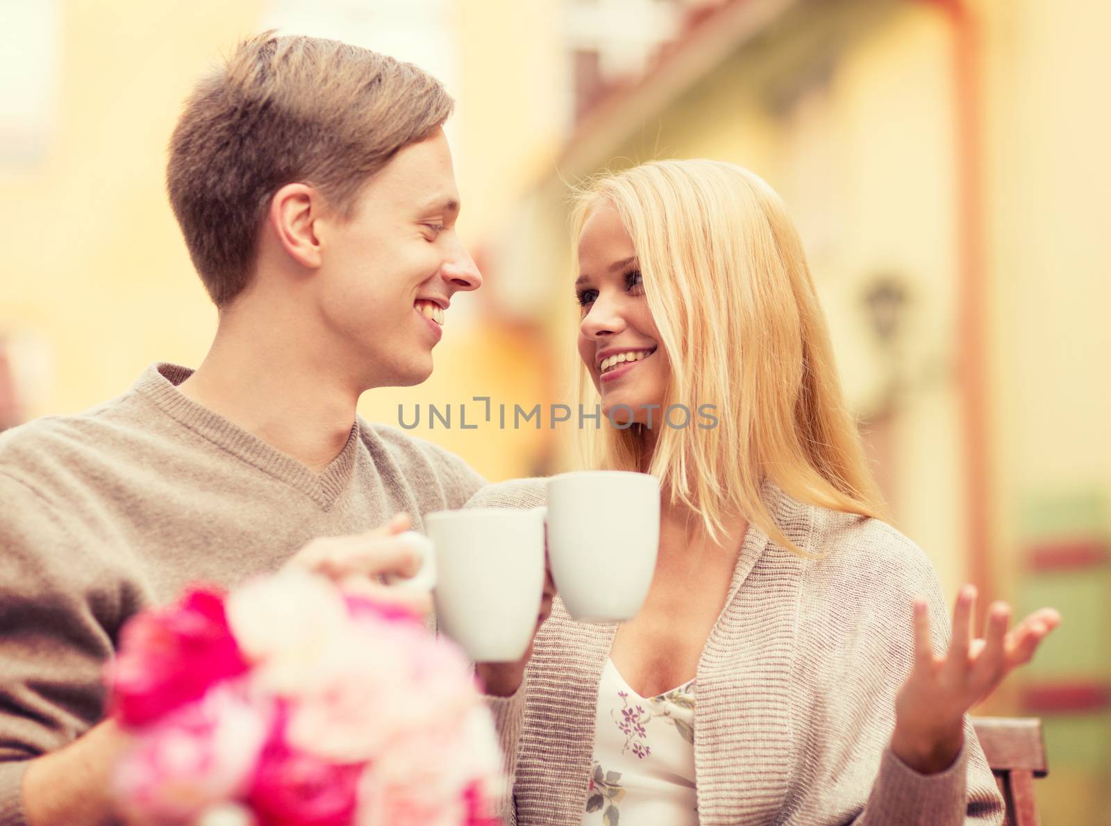 summer holidays, love, travel, tourism, relationship and dating concept - romantic happy couple in the cafe