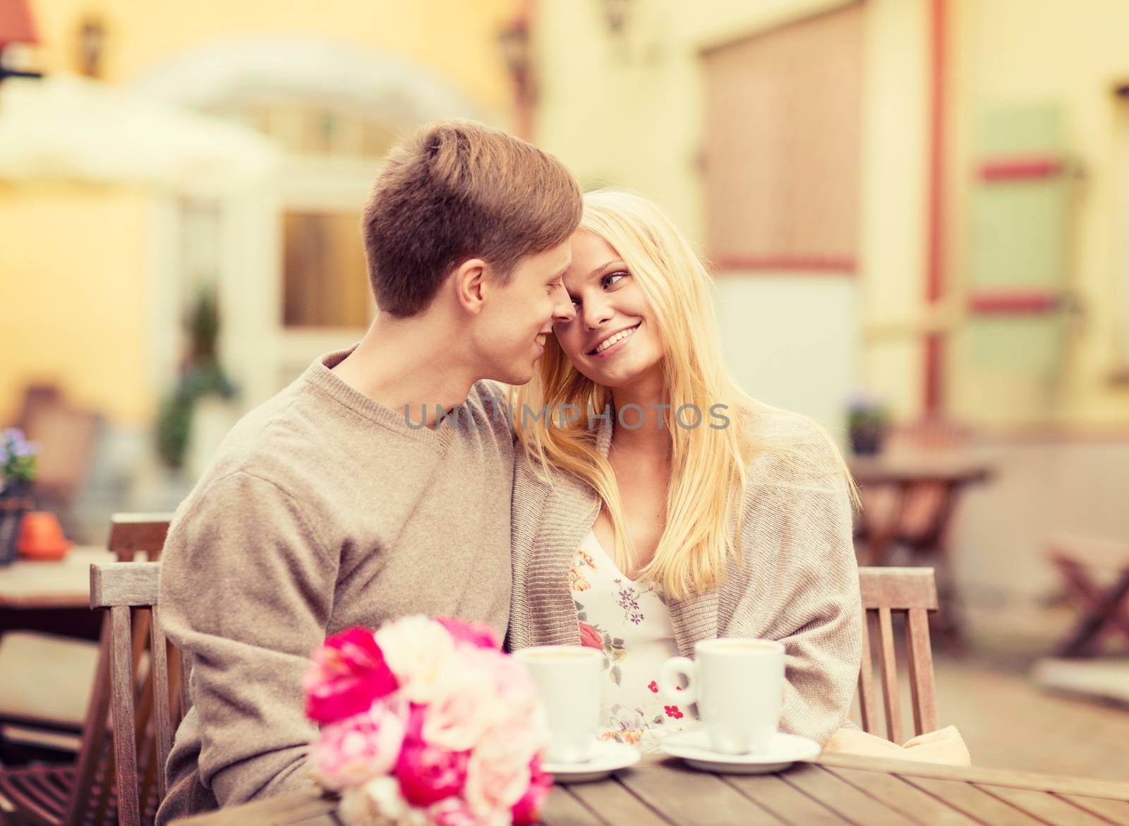 romantic happy couple kissing in the cafe by dolgachov