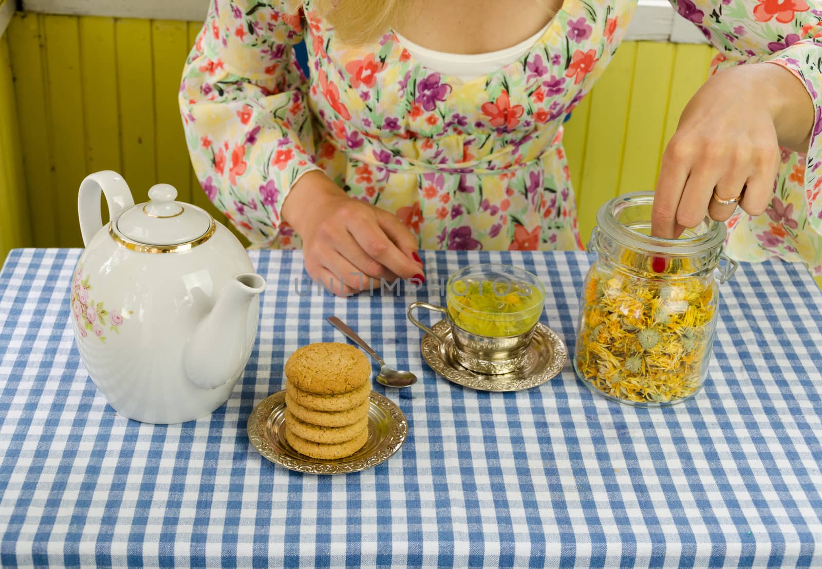 hand prepare marigold herb tea by sauletas