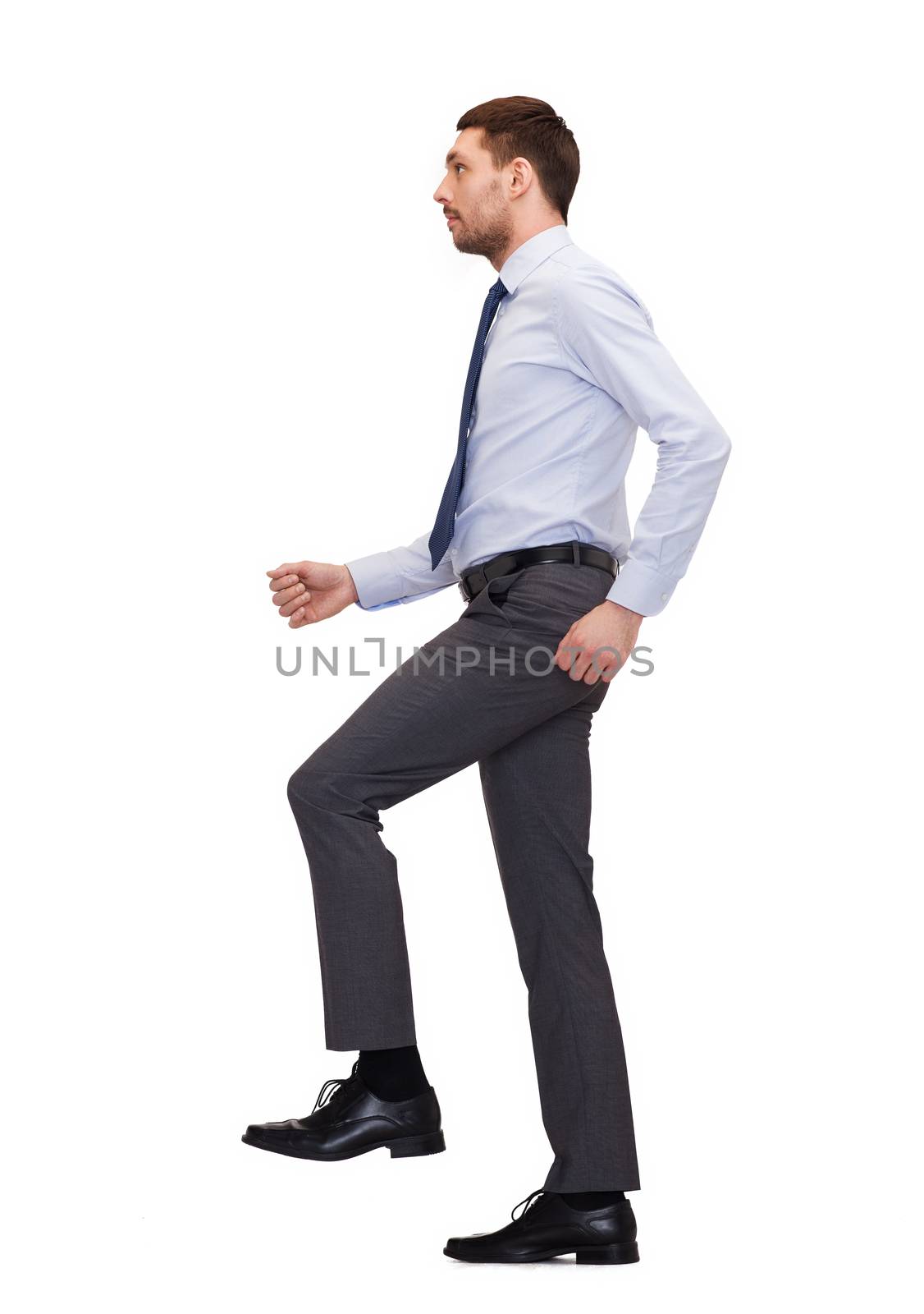 business and education concept - serious businessman stepping on imaginary step