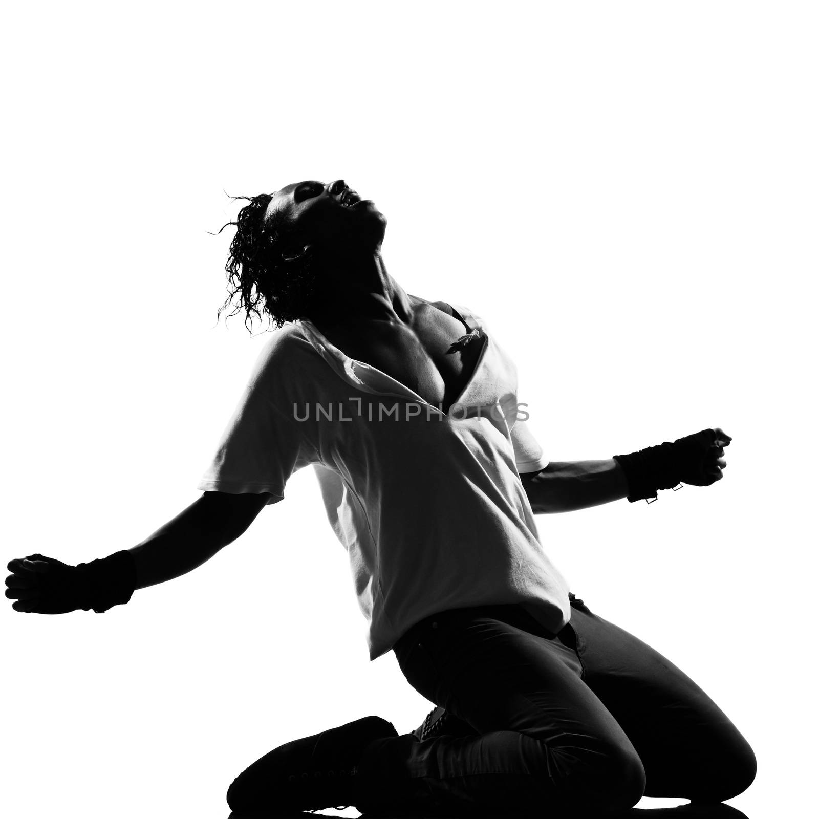 full length silhouette of a young man dancer dancing kneeling screaming funky hip hop r&b on isolated studio white background