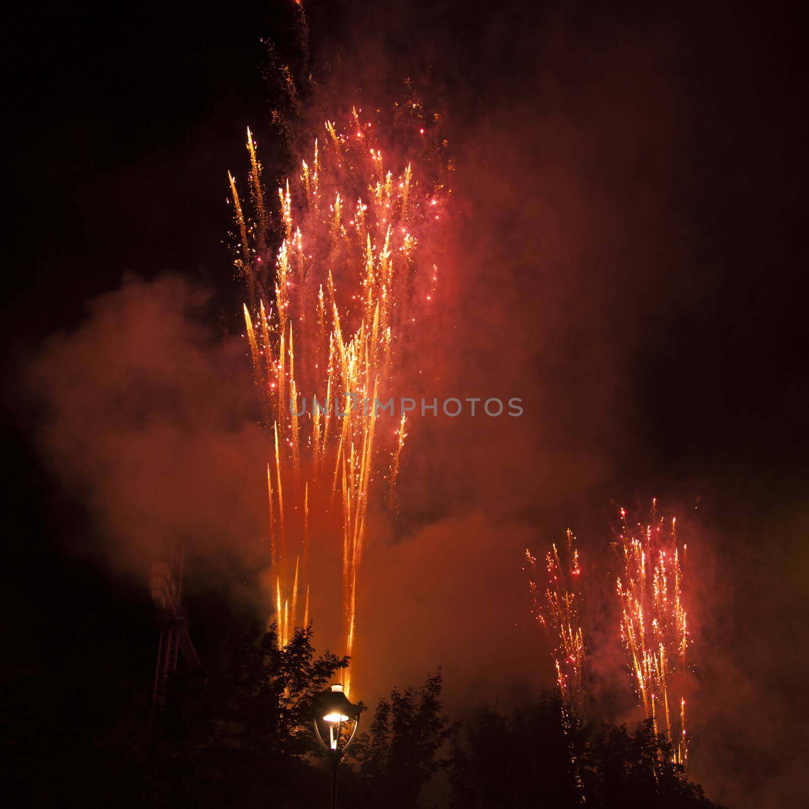 Red fireworks exploding in the black sky