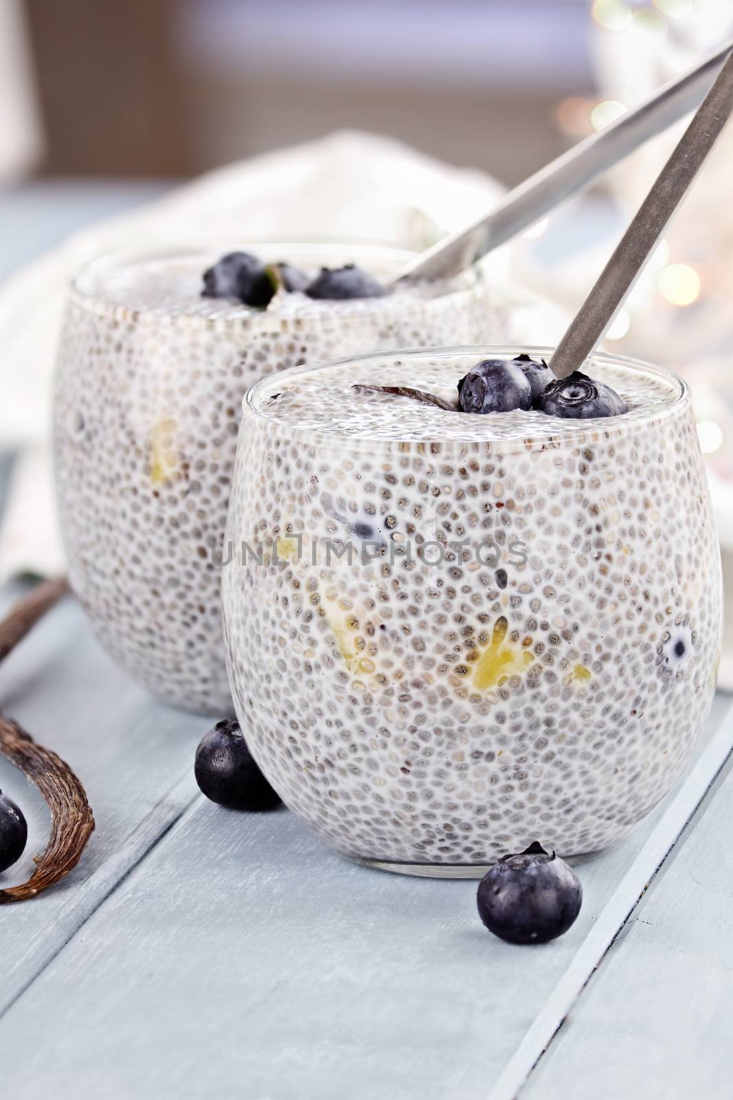 Chia seed pudding made with mangos and blueberries with extreme shallow depth of field.