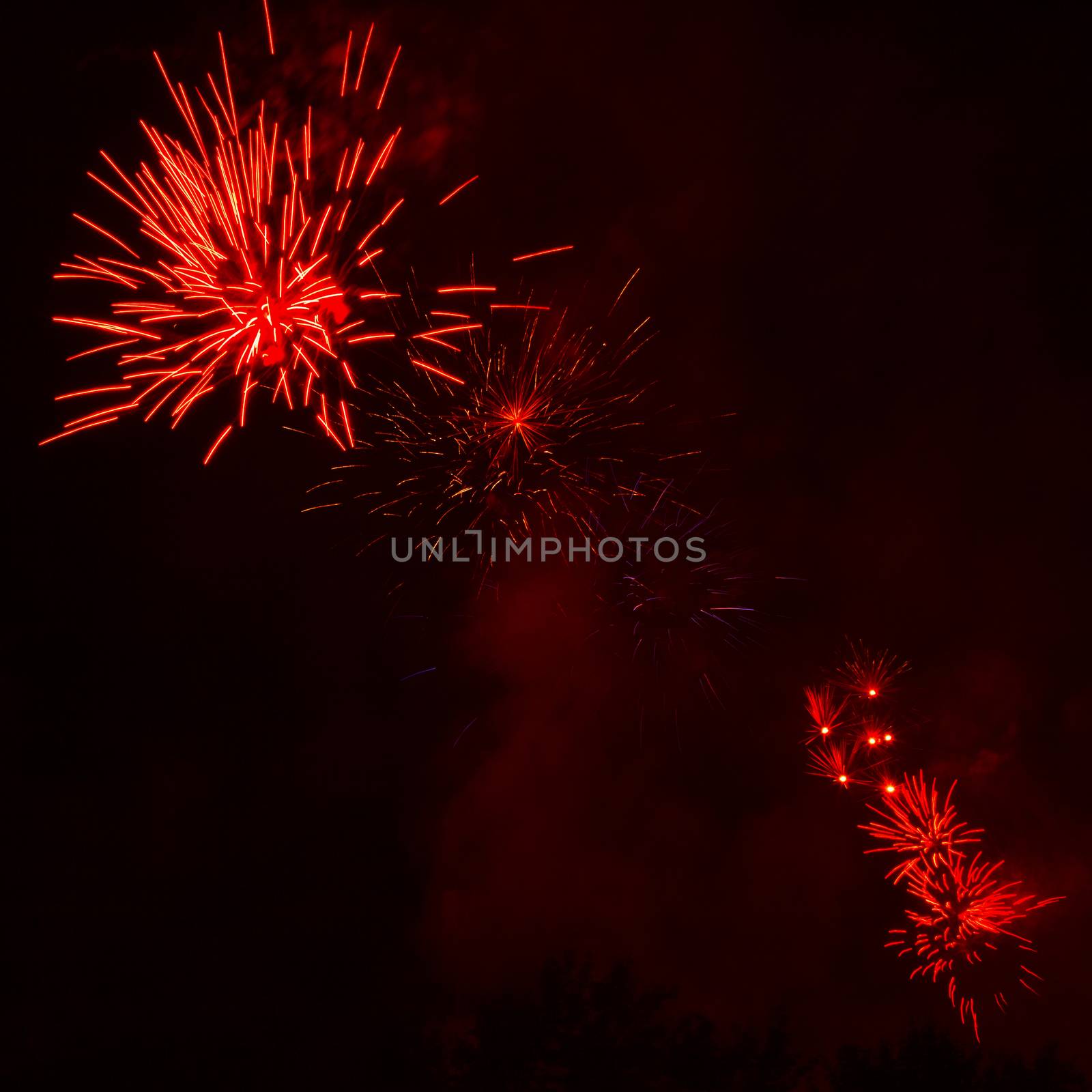 Red fireworks exploding in the black sky