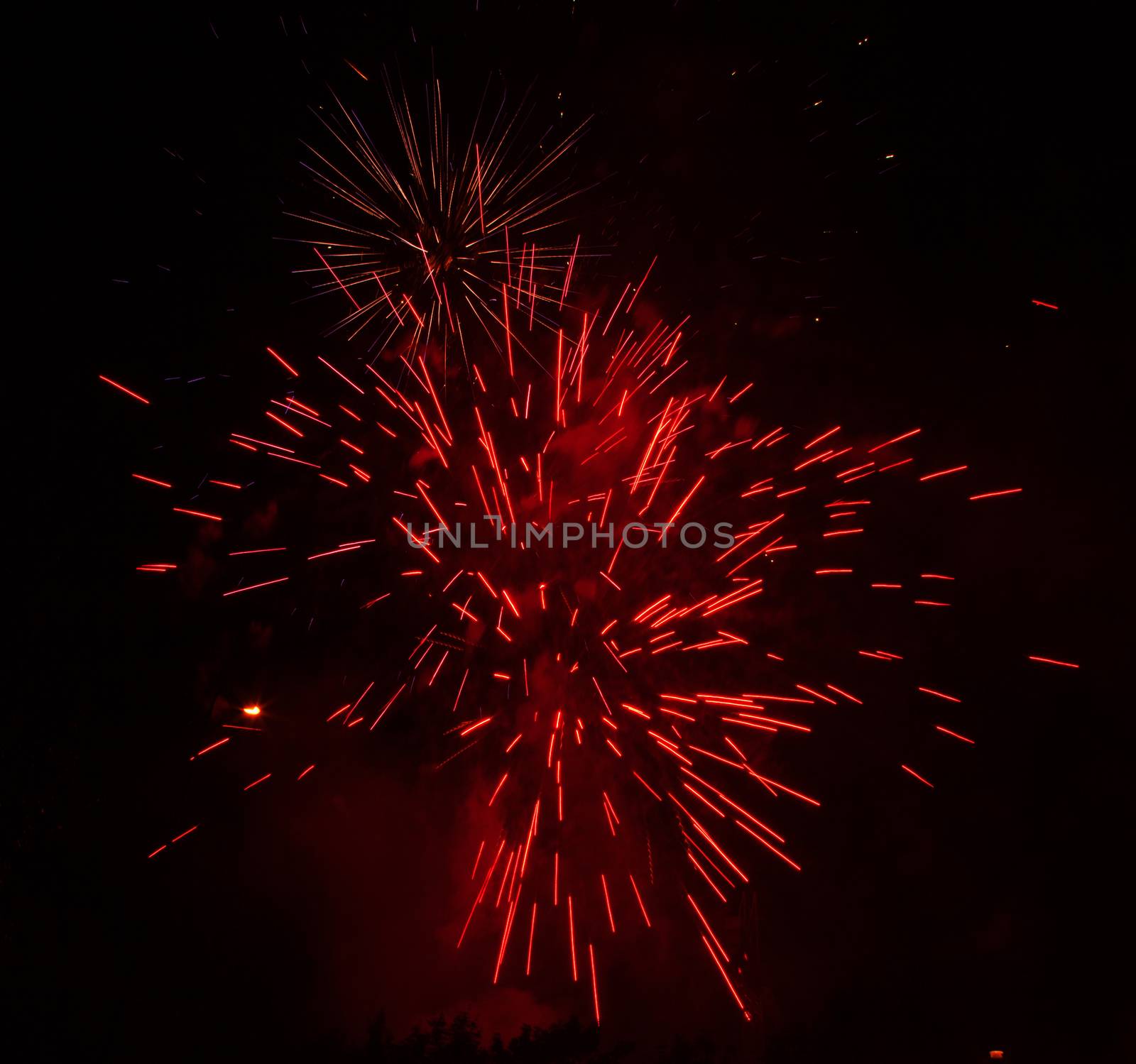 Red fireworks exploding in the black sky