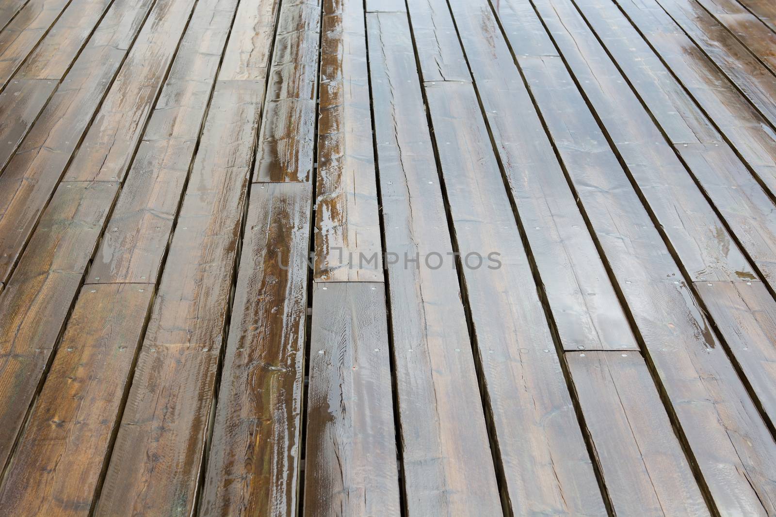 Wet wooden planks background pattern on a rainy day