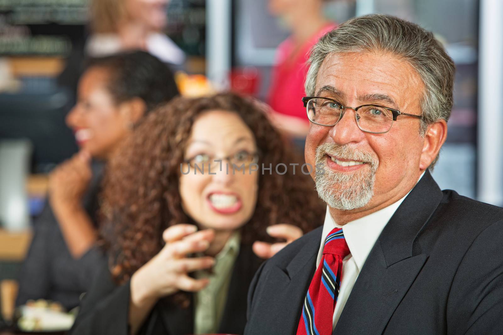 Angry woman trying to strangle naive businessman