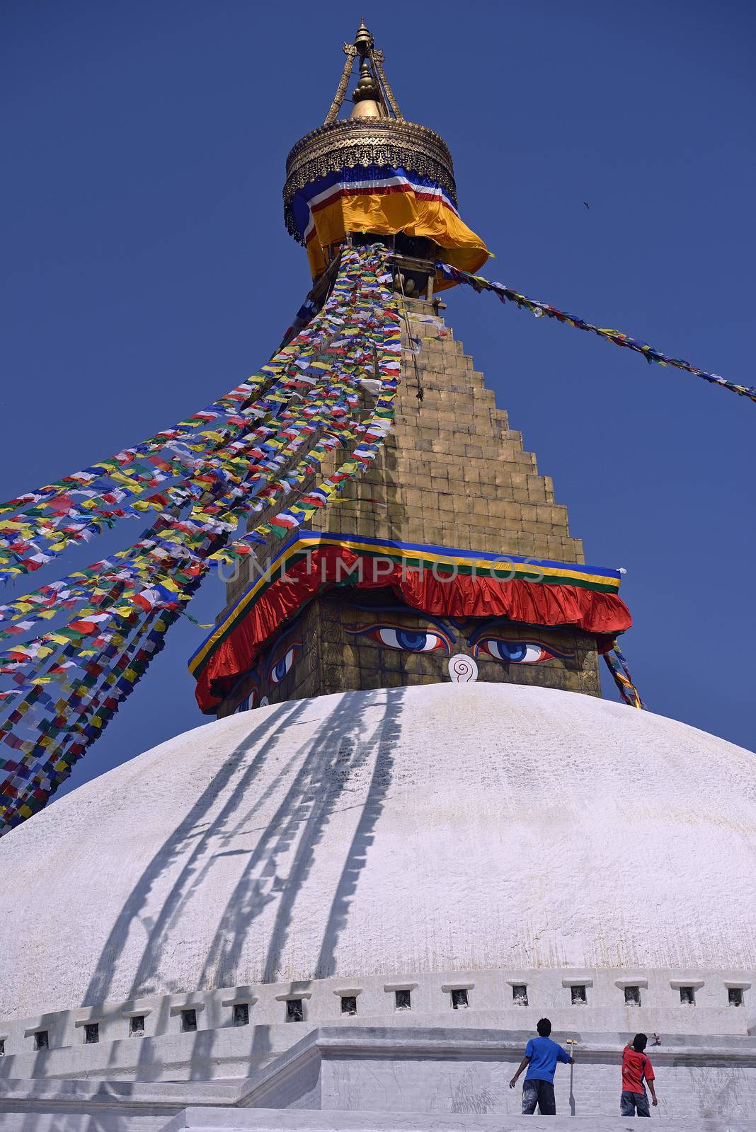 workers painting Bodhnath Stupa in Kathmandu, Nepal.