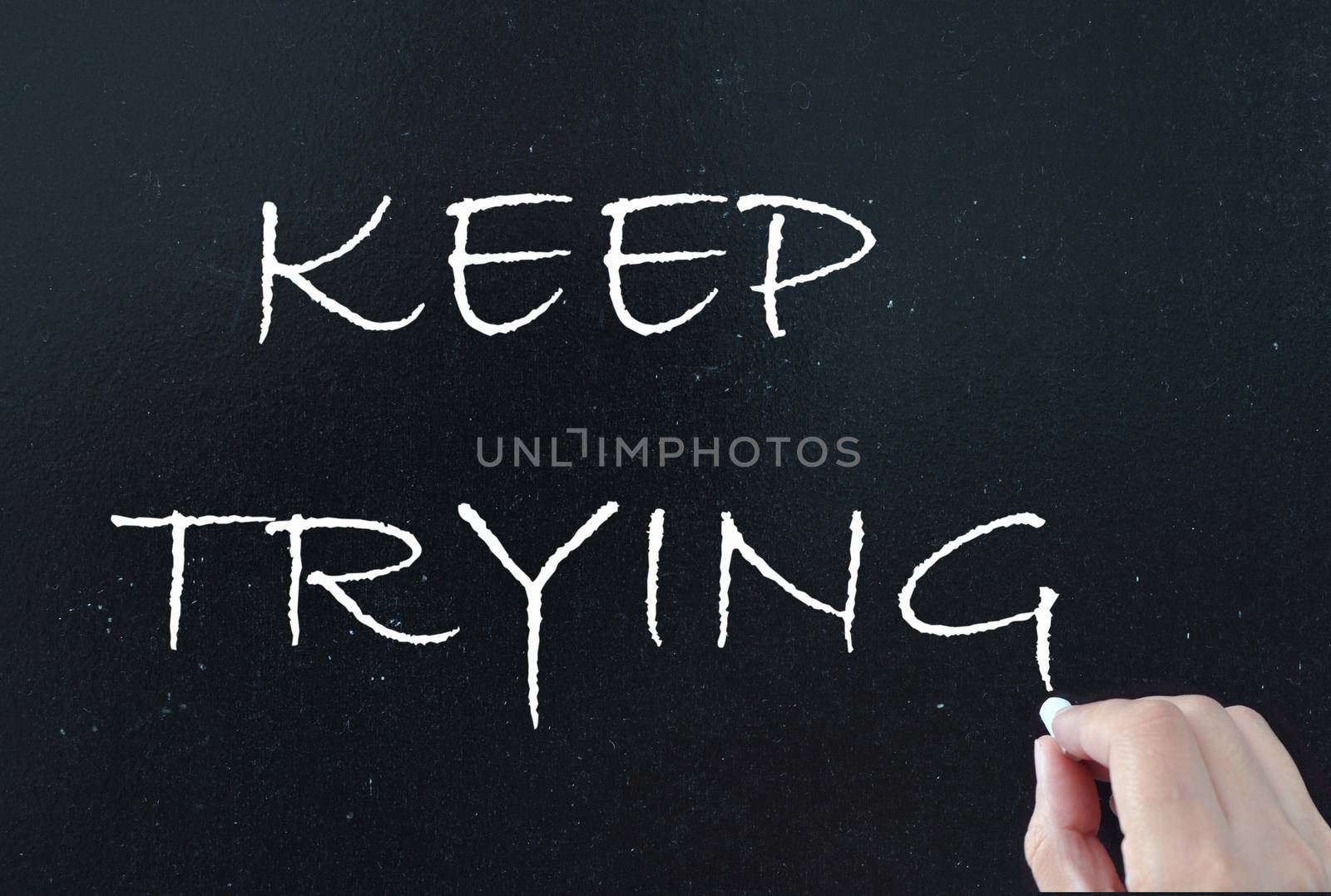 Keep trying hand written on a chalkboard