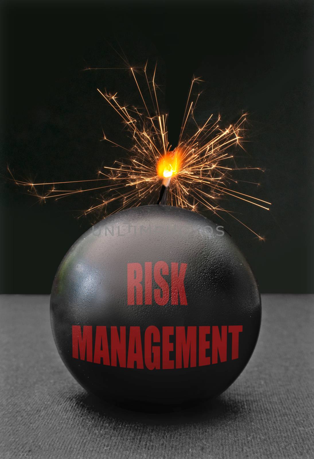Exploding bomb labeled risk management with burning fuse 
