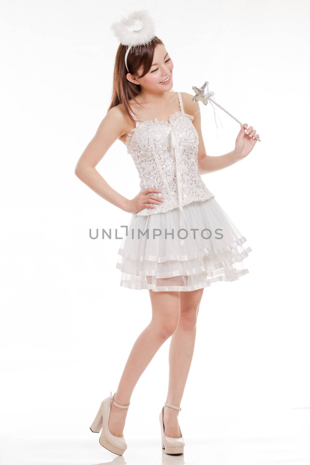 Malay woman in white angel fairy costume with wand