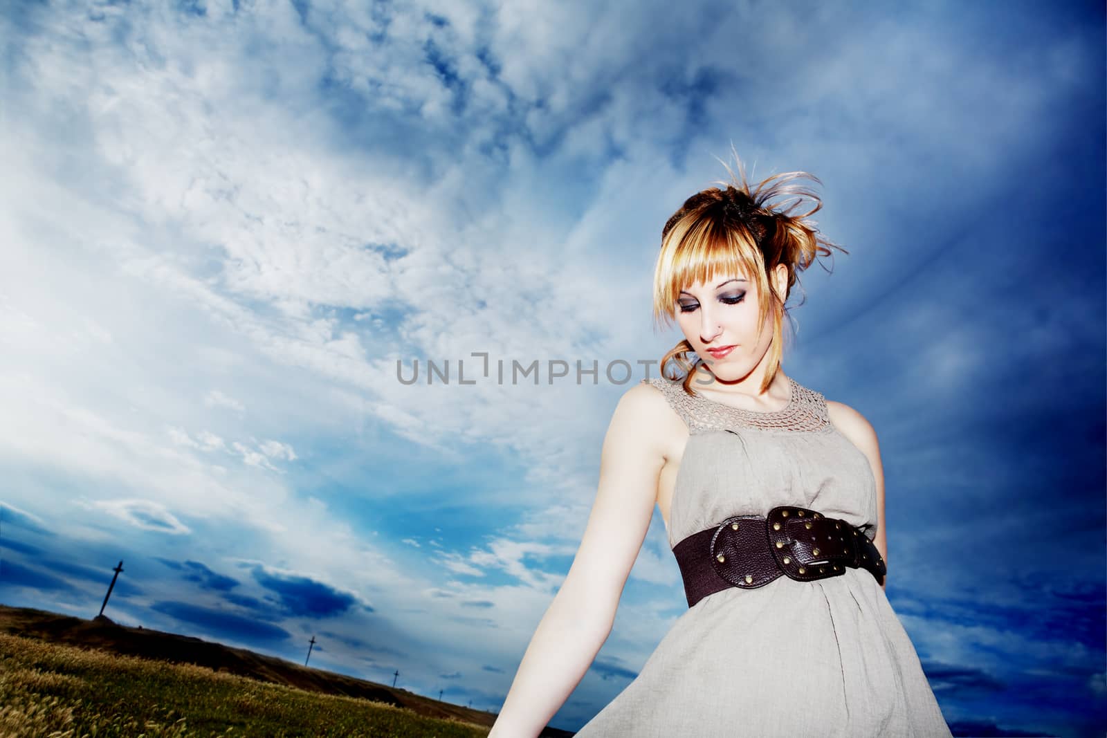 Fashion. Portrait girl outdoors wearing dress and belt with blue sky
