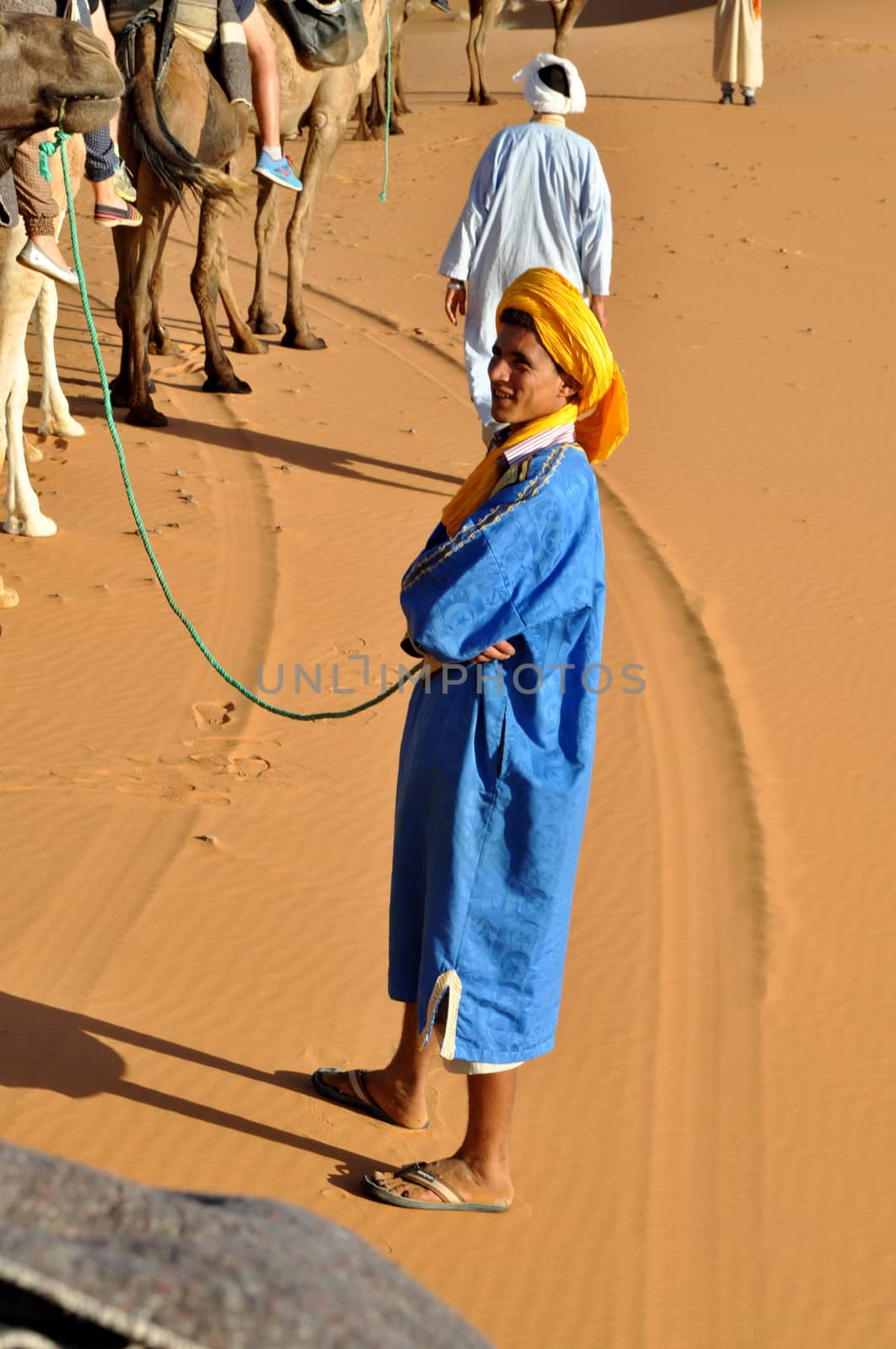 MERZOUGA DESERT - OCTOBER 01: Man in traditional Berber wear, walking in Merzouga Desert, Morocco on October 01, 2013.