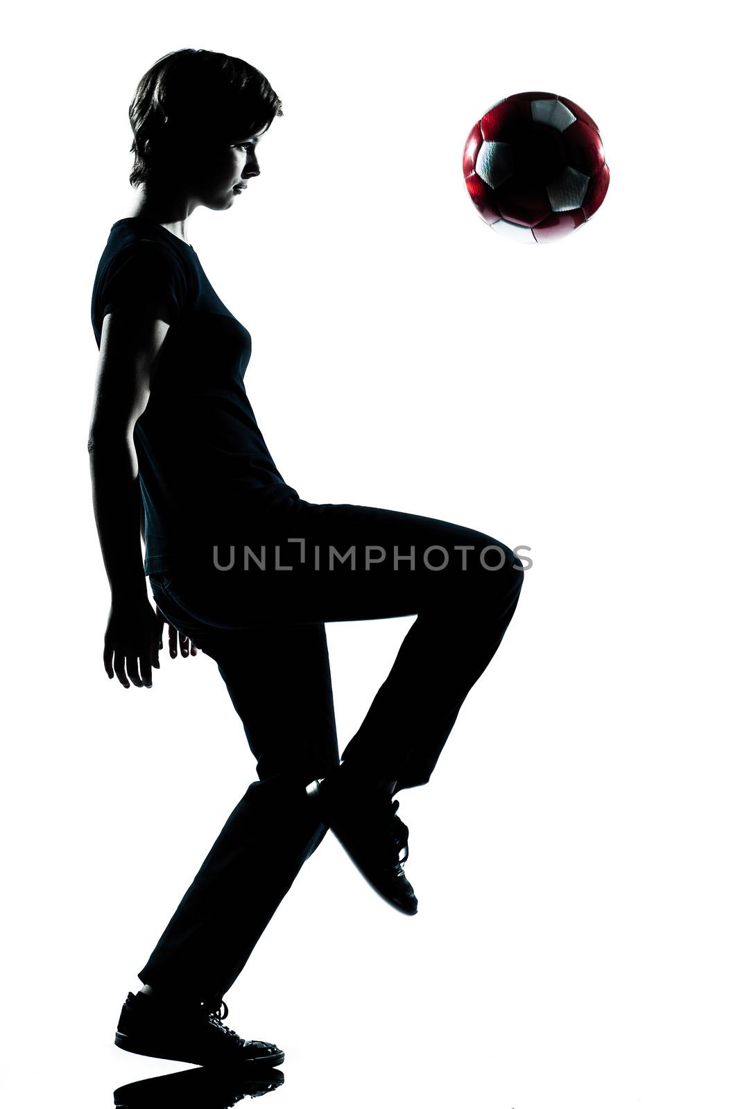 one young teenager boy silhouette juggling soccer football by PIXSTILL