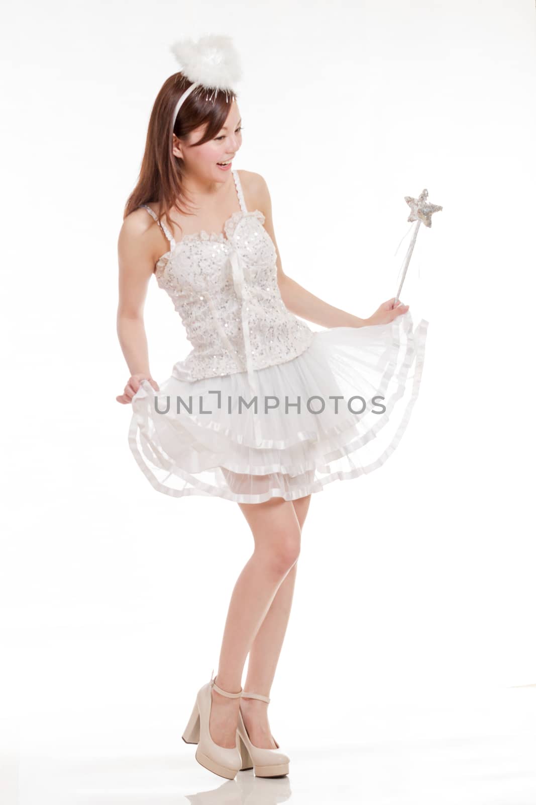 Malay woman in white angel fairy costume holding wand