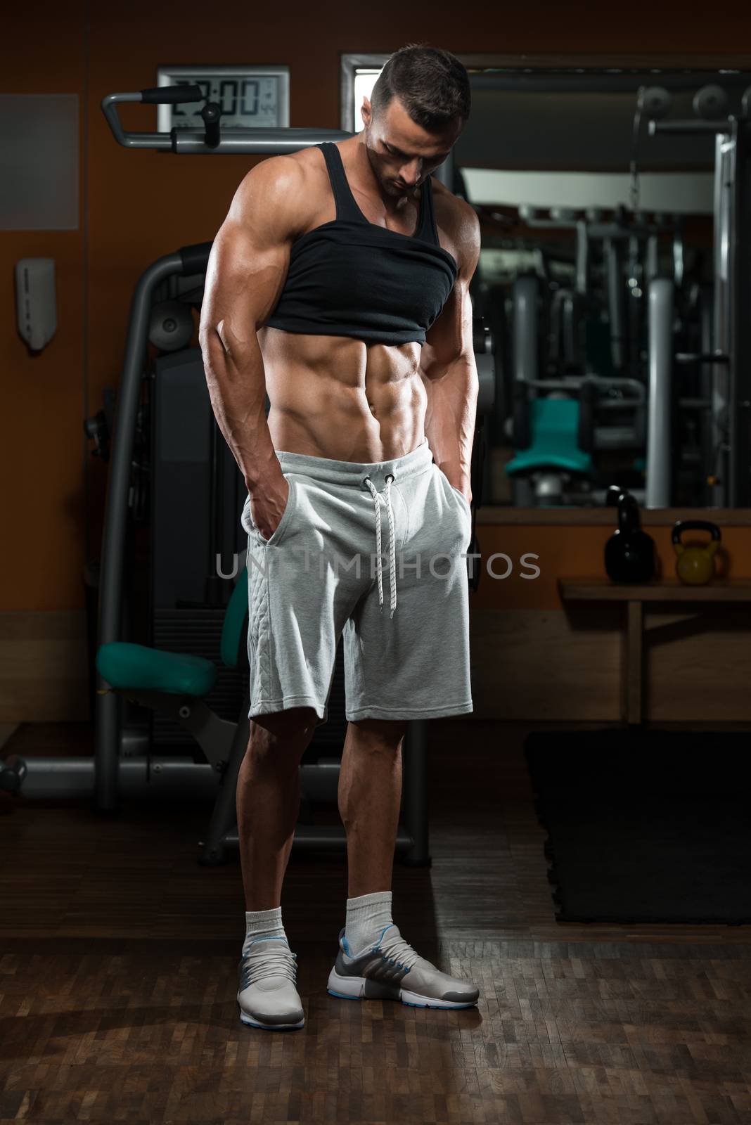 Portrait Of A Physically Fit Young Man In A Healthy Club by JalePhoto