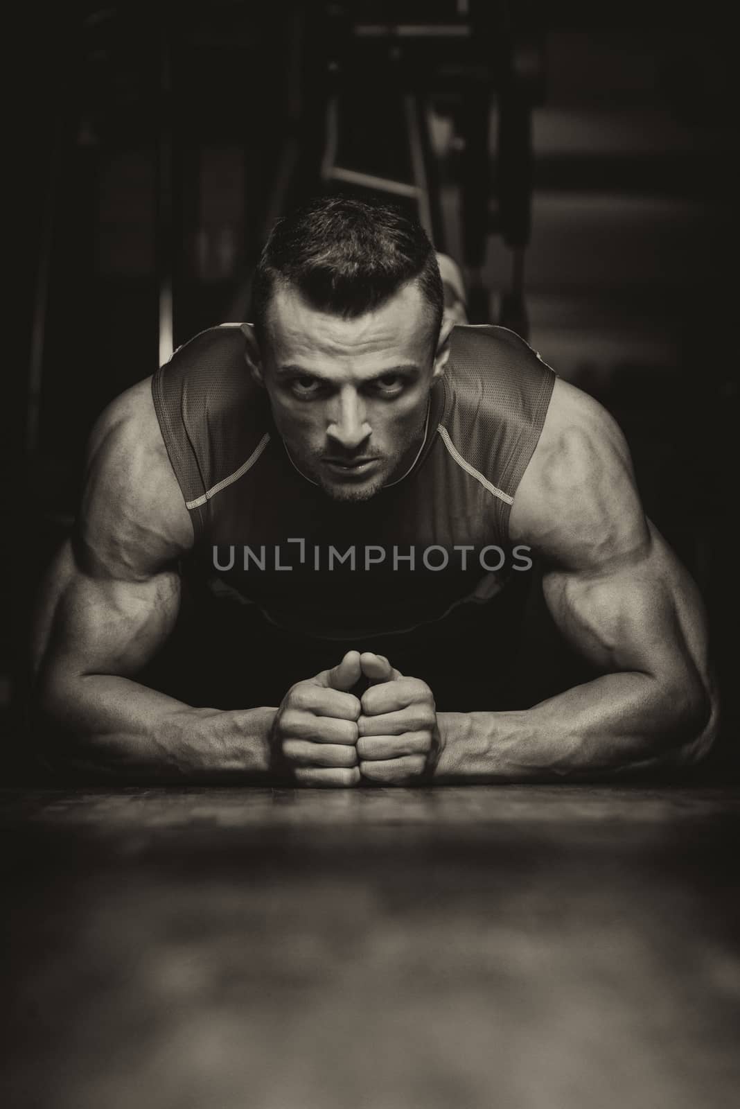 Young Man Exercising Pushups by JalePhoto