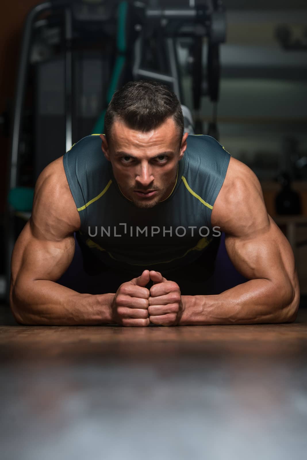 Young Man Exercising Pushups by JalePhoto