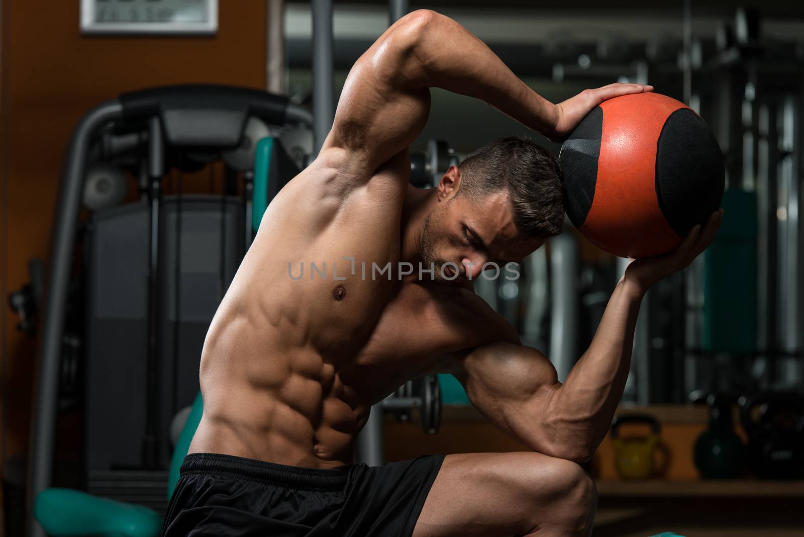 Muscular Man Exercise With Medical Ball