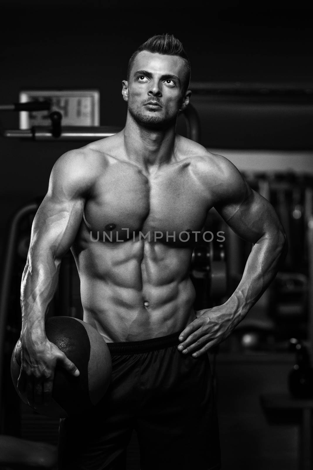 Muscular Man Exercise With Medical Ball by JalePhoto
