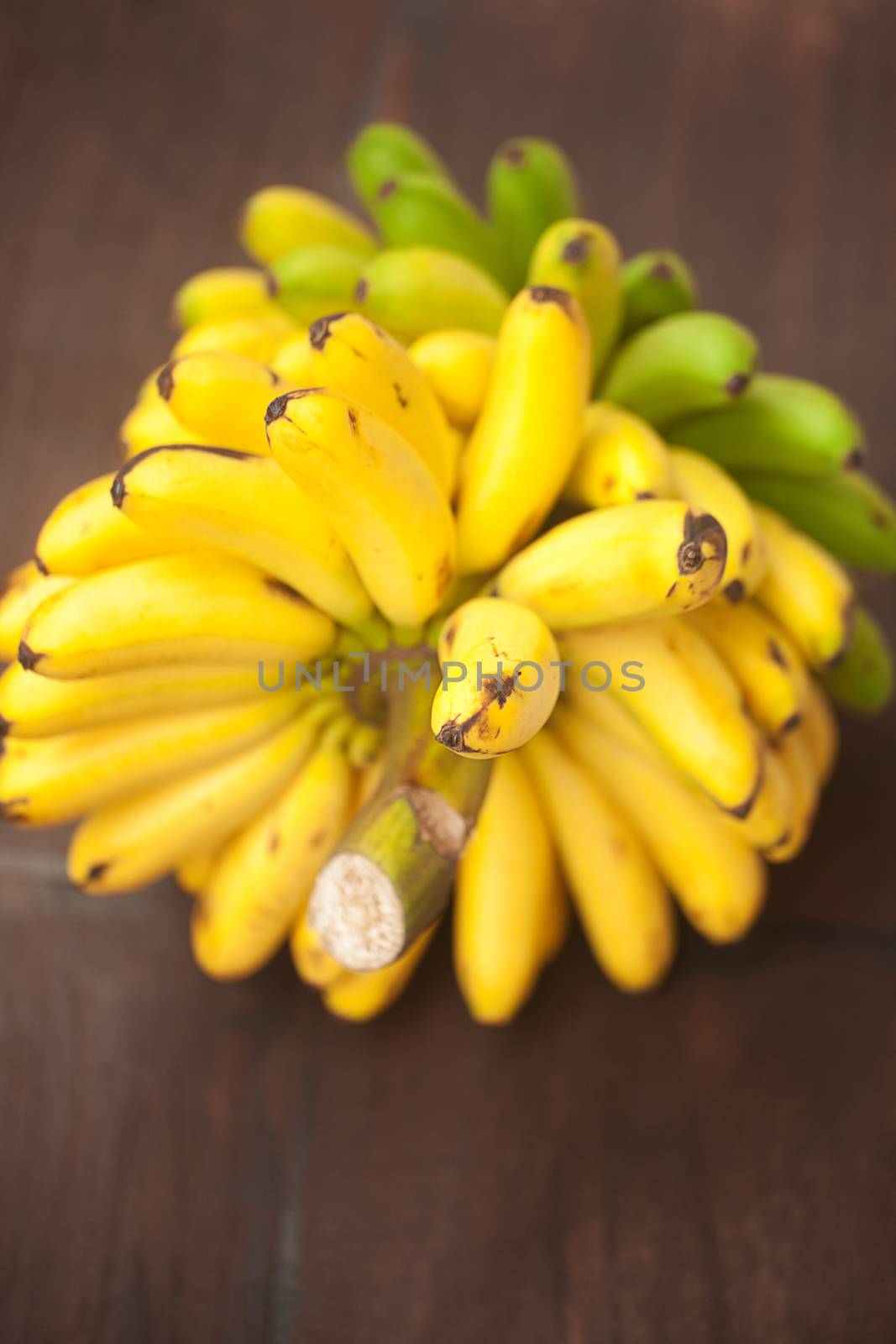 bunch of bananas on a wooden surface