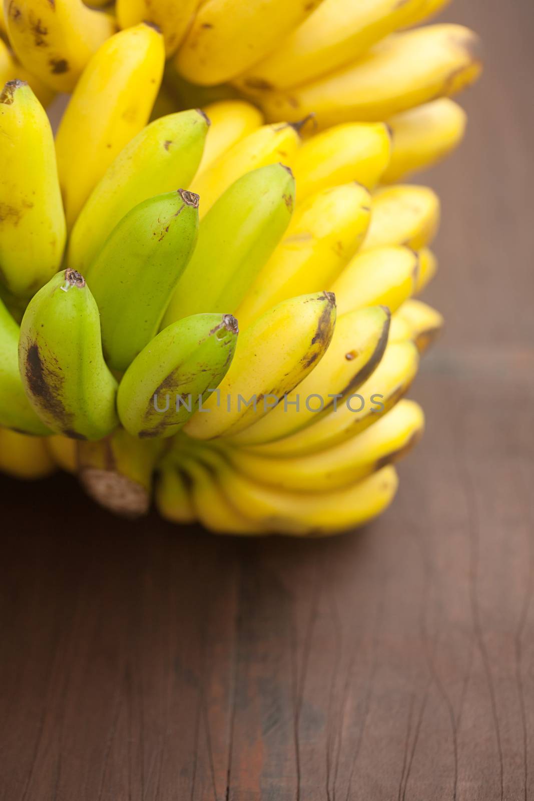 bunch of bananas on a wooden surface