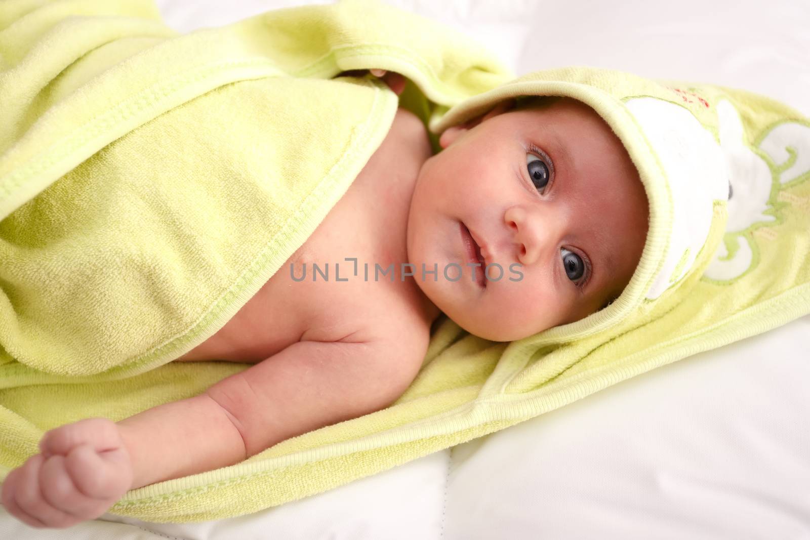 cute infant wrapped in a towel after bath