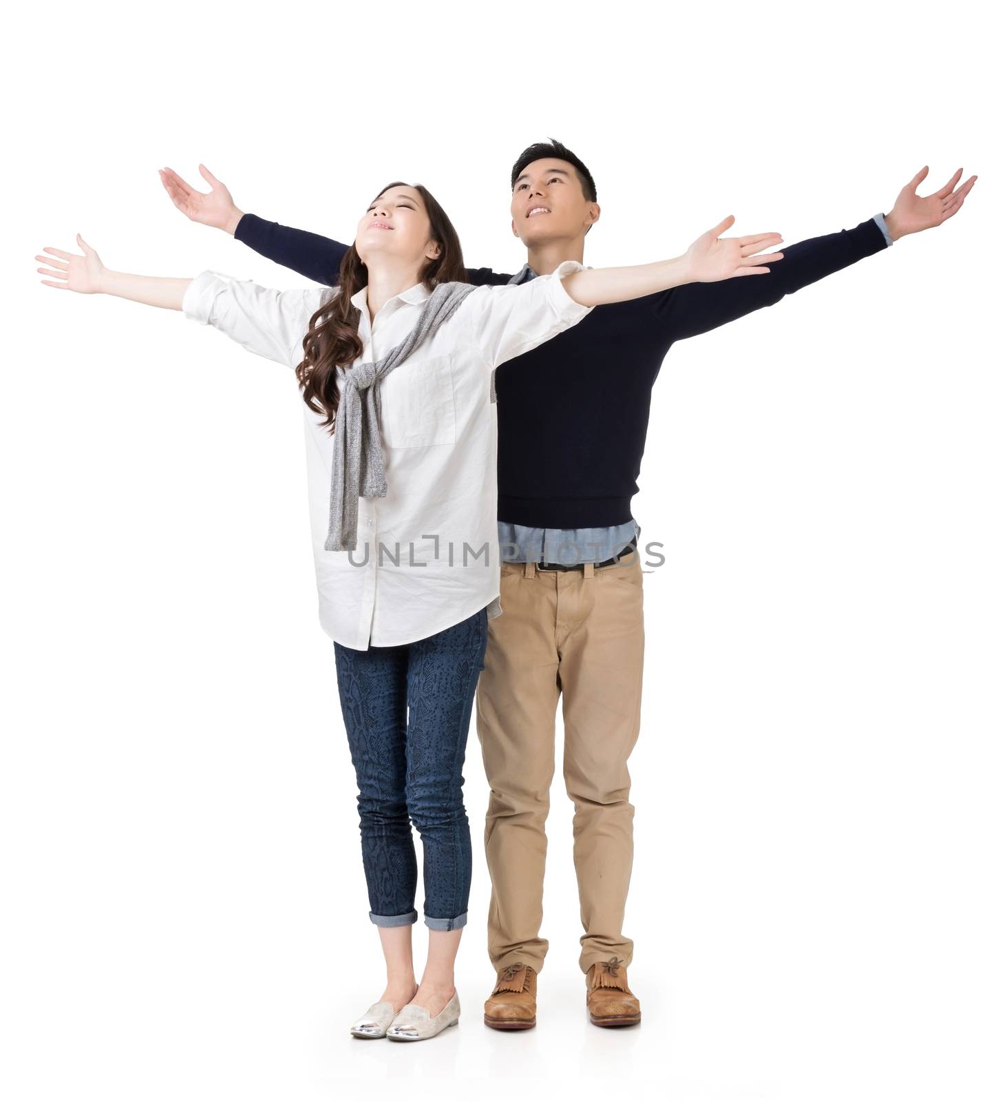 Asian couple open arms feel free, full length portrait isolated on white background.