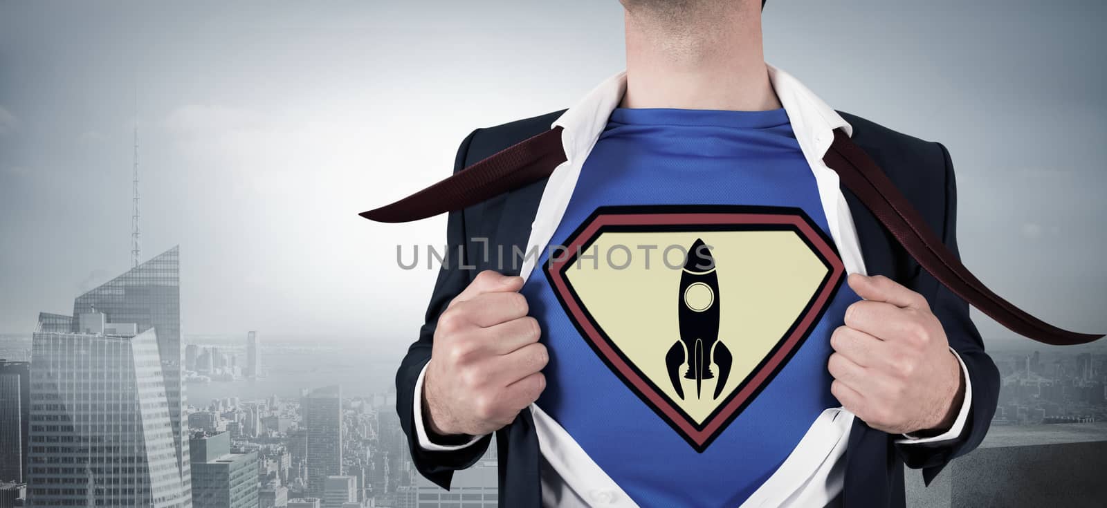 Businessman opening shirt in superhero style against misty cityscape