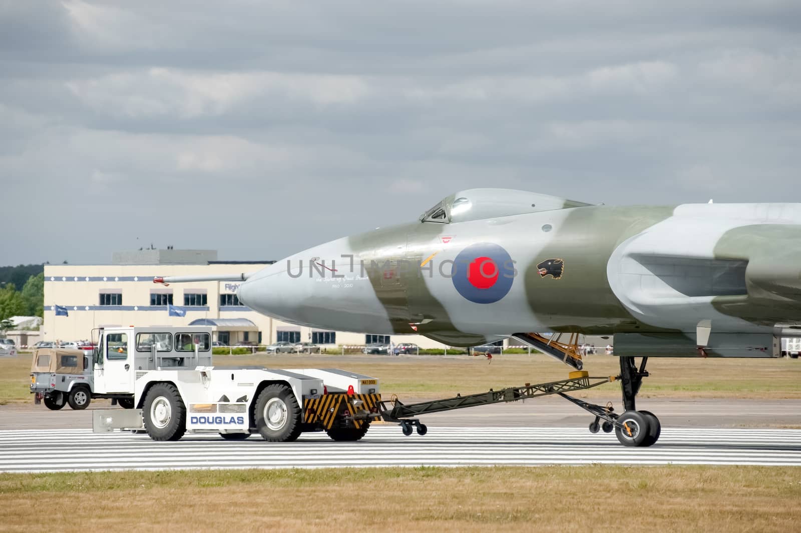Farnborough, UK - July 24, 2010: Vulcan bomber XH558 being towed by an airfield tug truck at the Farnborough Airshow, UK