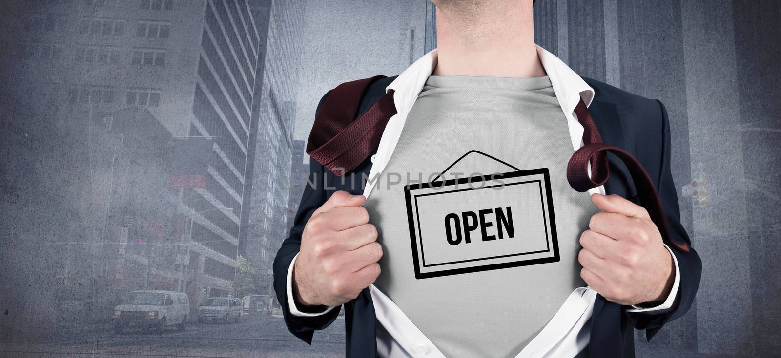 Businessman opening shirt in superhero style against urban projection on wall