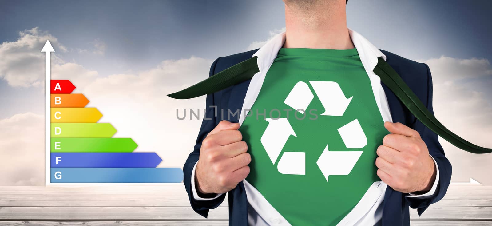 Businessman opening shirt in superhero style against graph showing energy rating chart