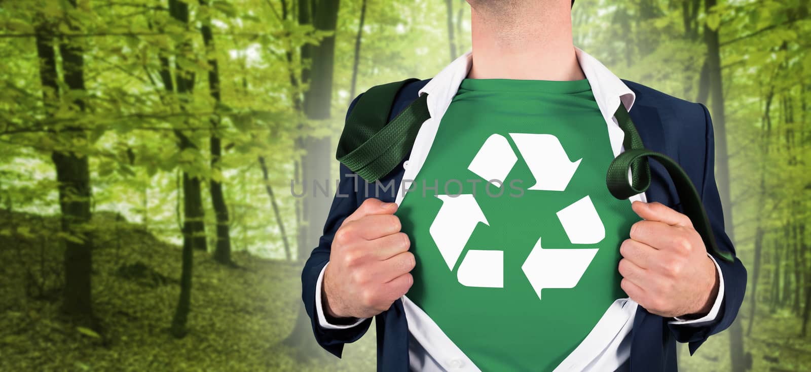 Businessman opening shirt in superhero style against peaceful green forest