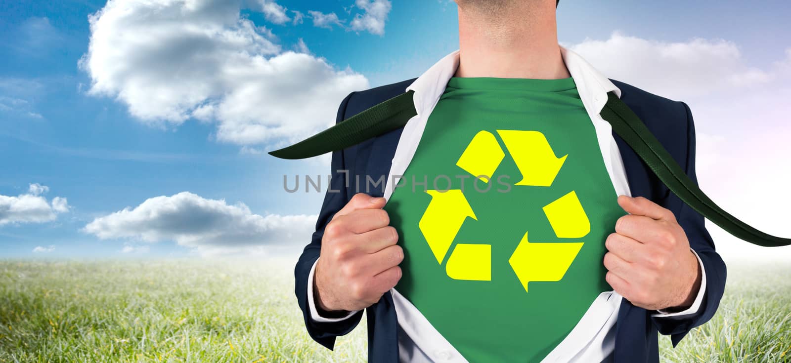 Businessman opening shirt in superhero style against sunny landscape