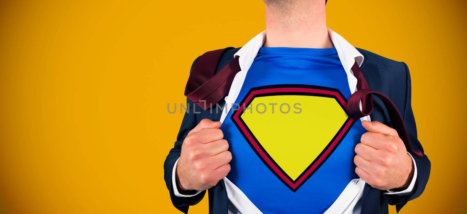 Businessman opening shirt in superhero style against yellow background with vignette