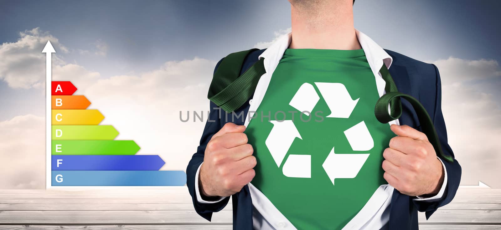 Businessman opening shirt in superhero style against graph showing energy rating chart