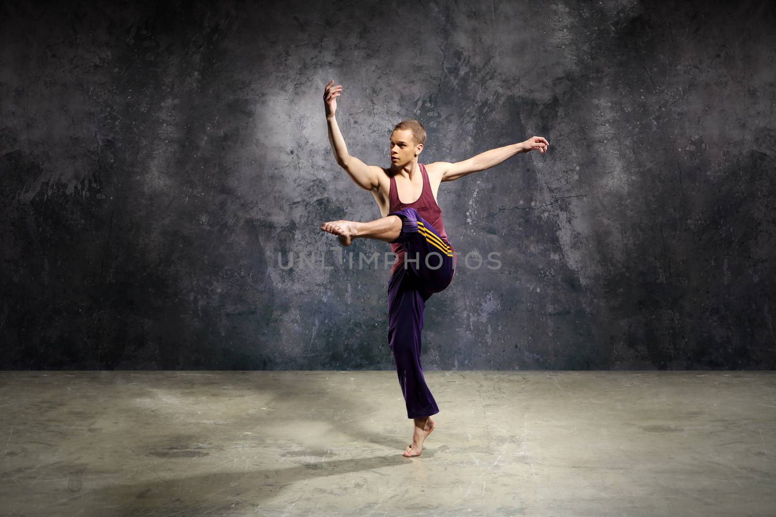 Young dancer is jumping on stage