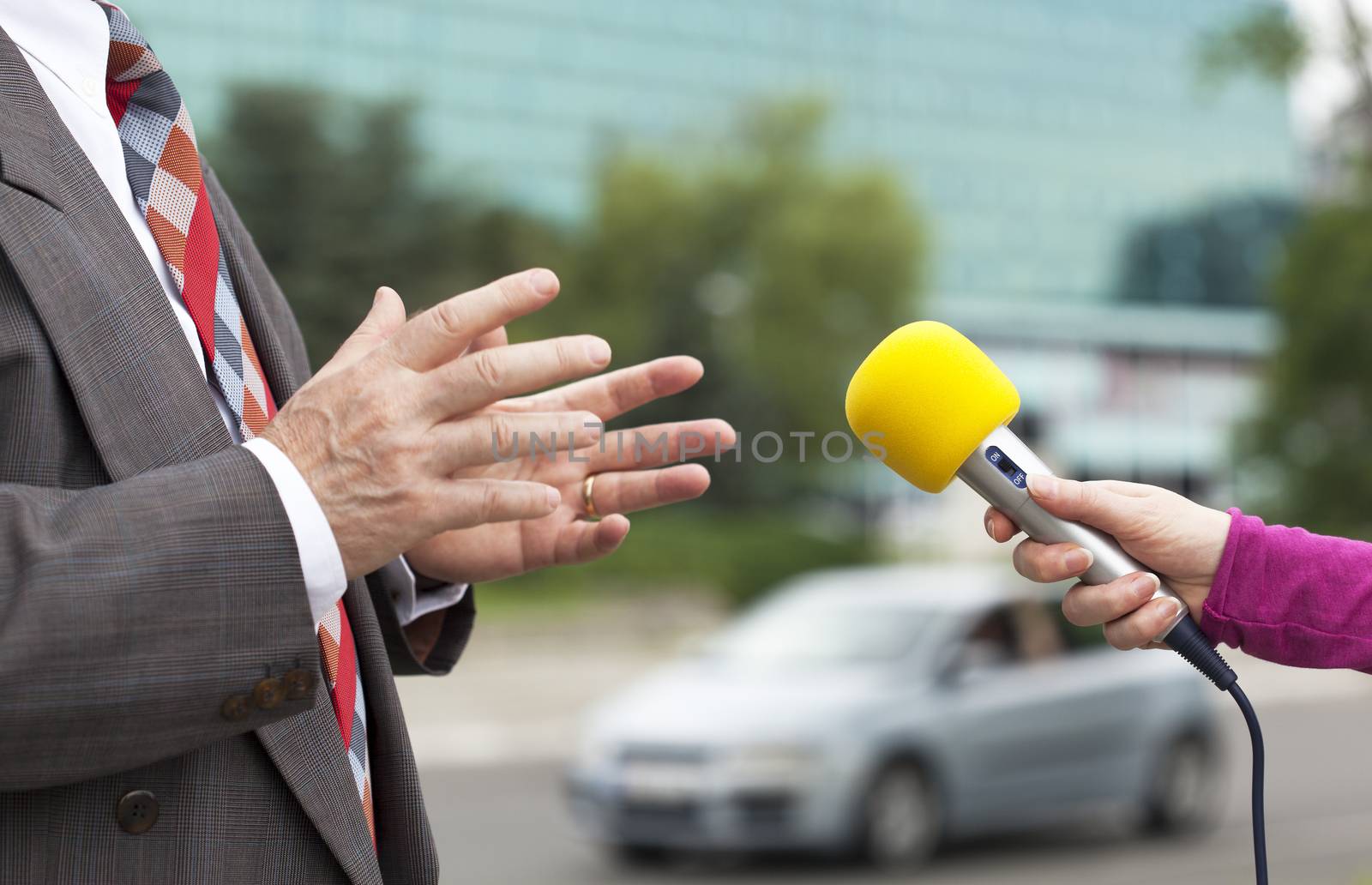 A journalist is making an interview with a microphone