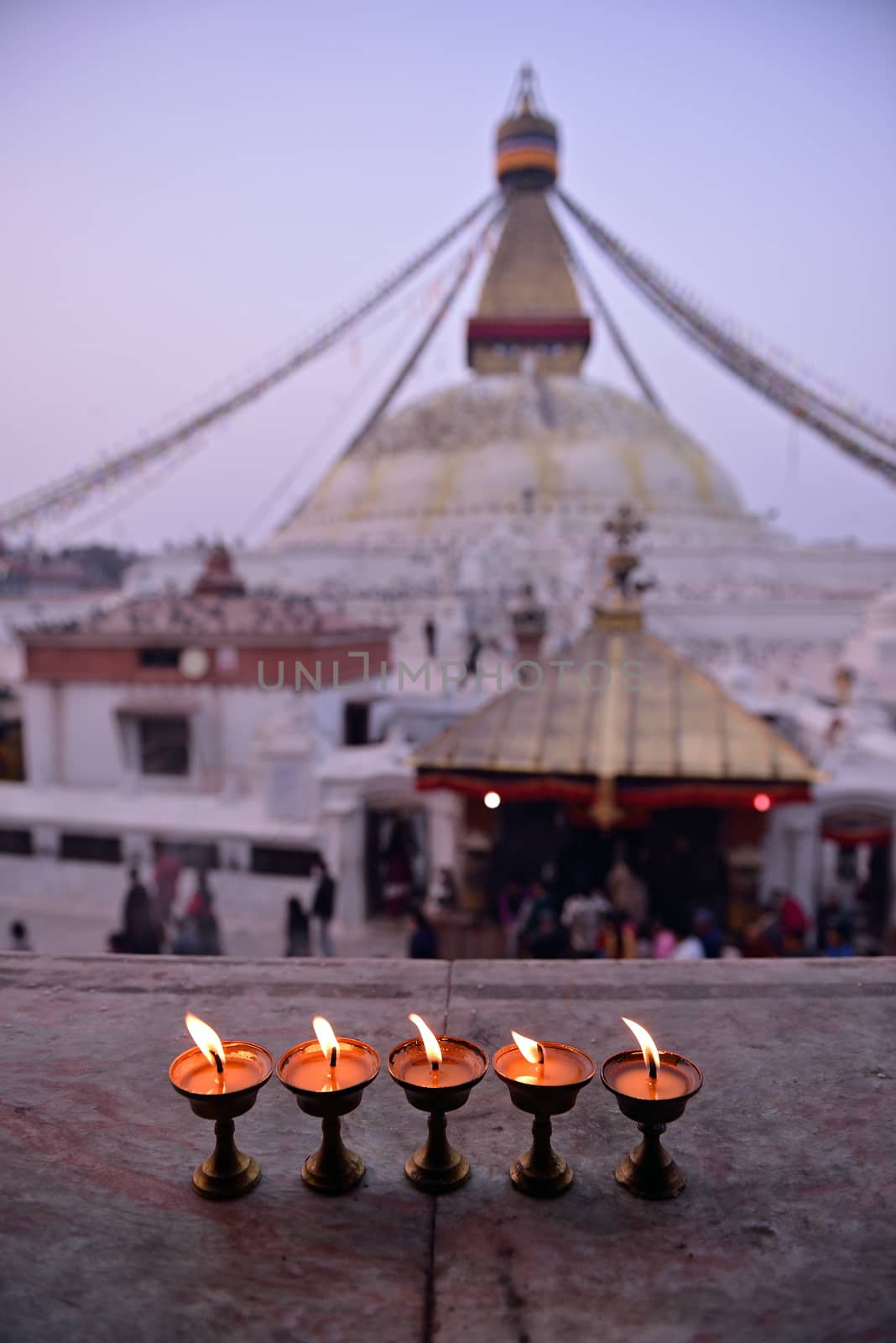 sacred candles in front of Boudha Nath (Bodhnath) stupa in kathm by think4photop