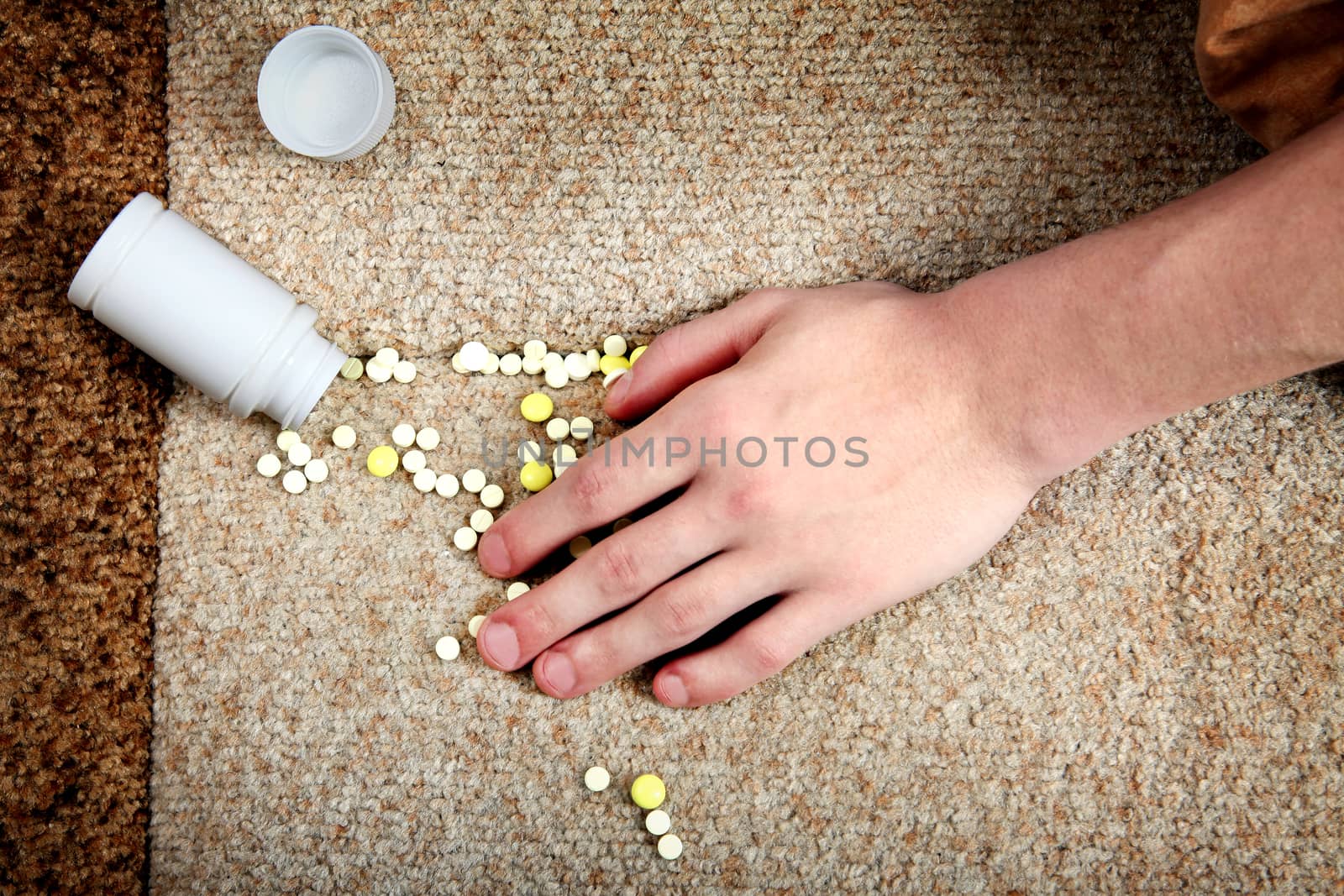 Hand near the scattering Pills by sabphoto