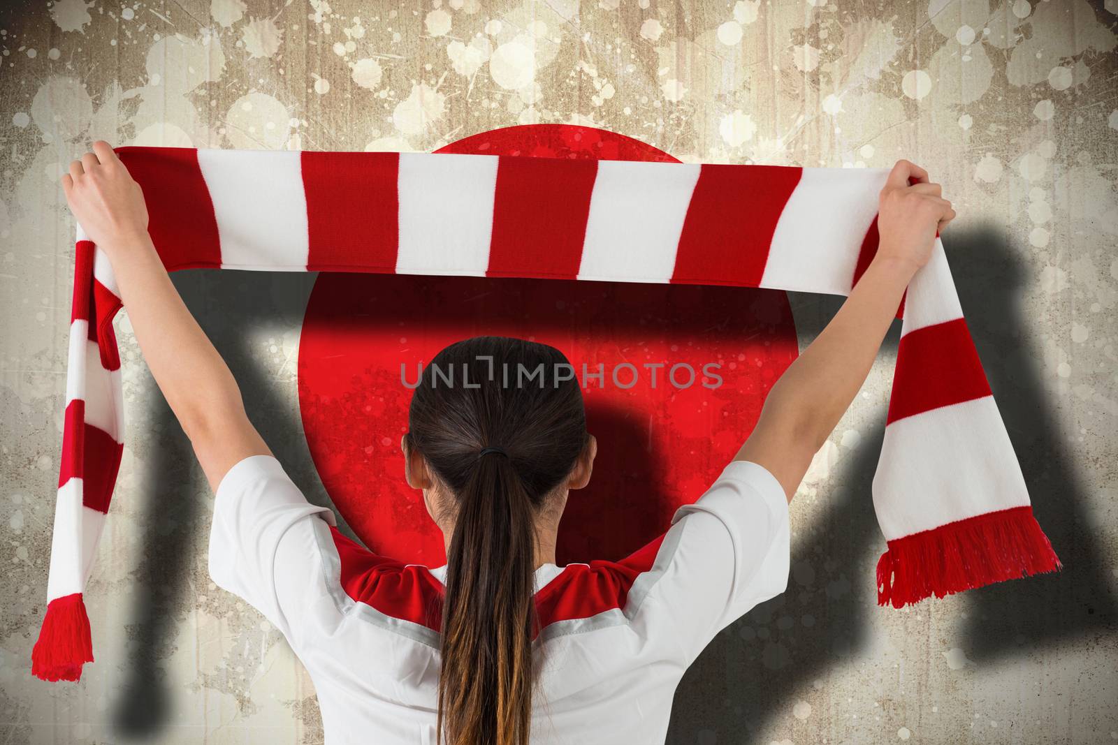 Football fan waving red and white scarf by Wavebreakmedia