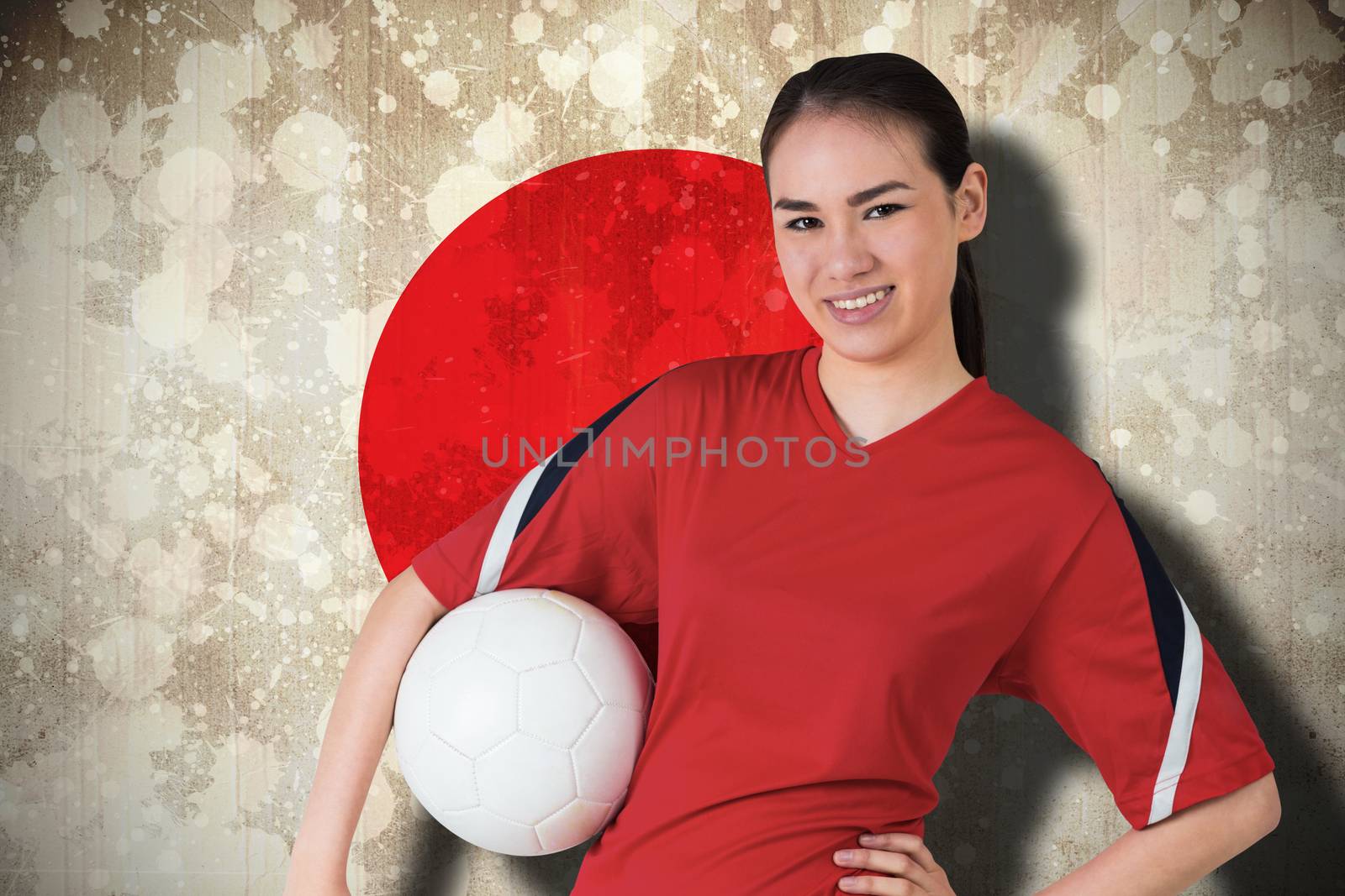 Smiling asian football fan looking at camera by Wavebreakmedia