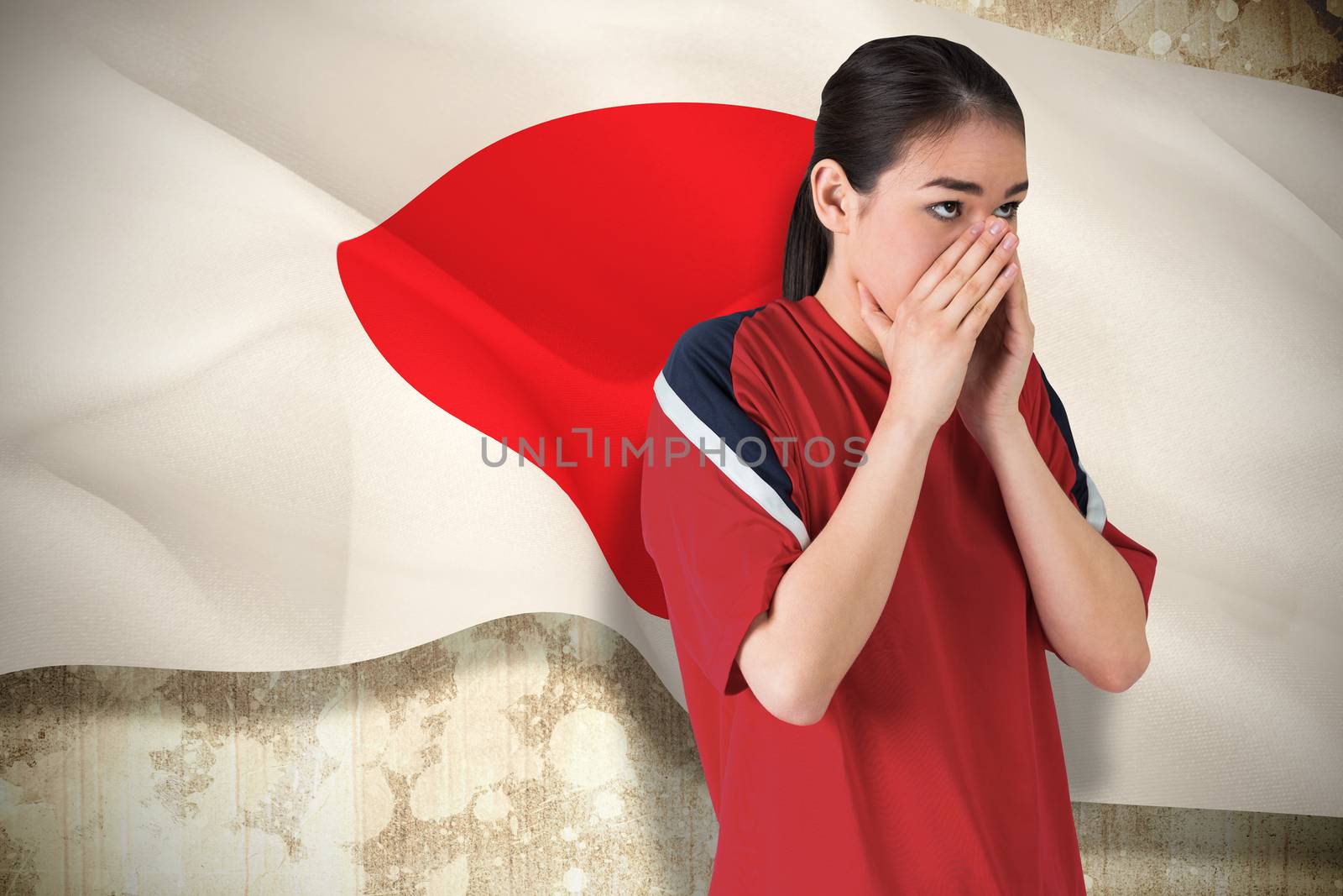 Composite image of nervous football fan looking ahead against japan flag