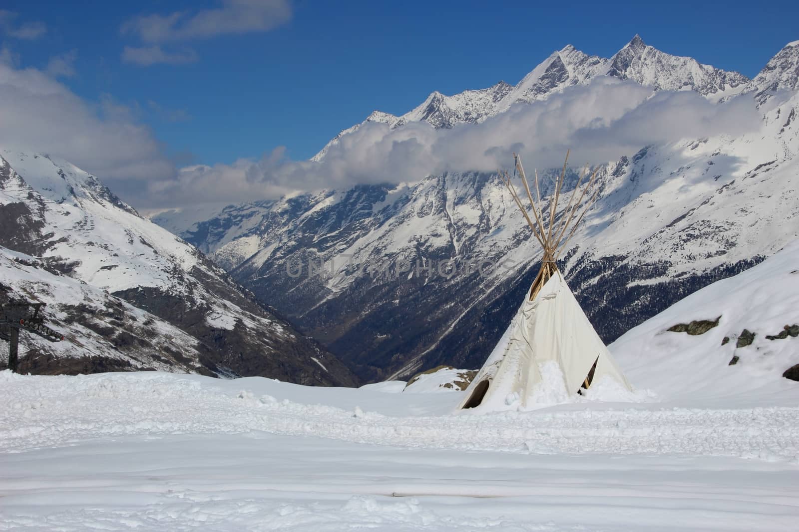 Indian style teepee tent set high up in the Swiss Alps.